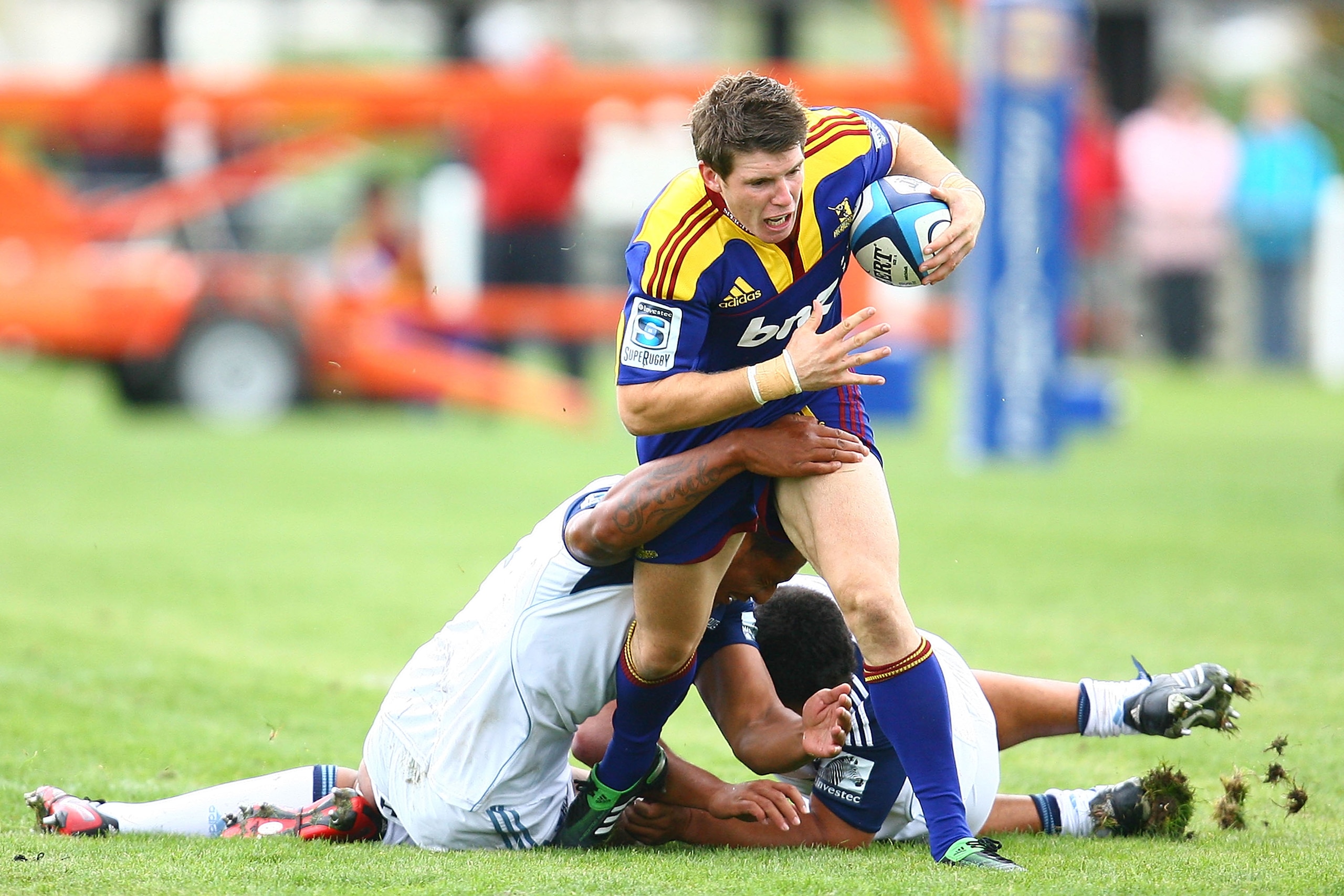 BALCLUTHA, NEW ZEALAND - JANUARY 29:  Colin Slade of the Highlanders is tackled during the Super Rugby trial match between the Highlanders and the Blues at AMP Showgrounds on January 29, 2011 in Balclutha, New Zealand.  (Photo by Teaukura Moetaua/Getty Im