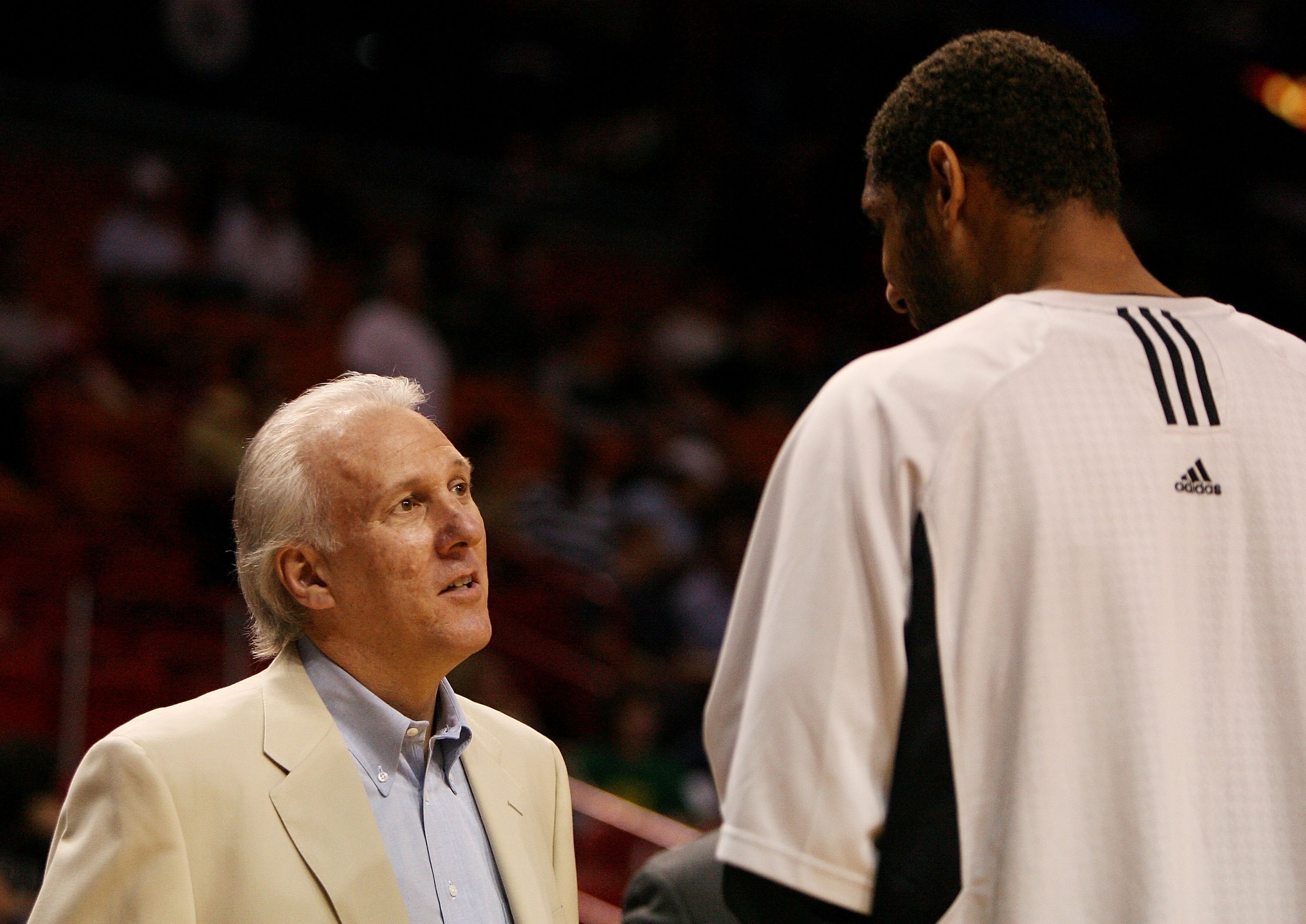 MIAMI - OCTOBER 23:  Head coach Greg Popovich of the San Antonio Spurs talks with Tim Duncan #21 prior to taking on the Miami Heat during warm-ups at American Airlines Arena on October 23,  2007 in Miami, Florida.  NOTE TO USER: User expressly acknowledge