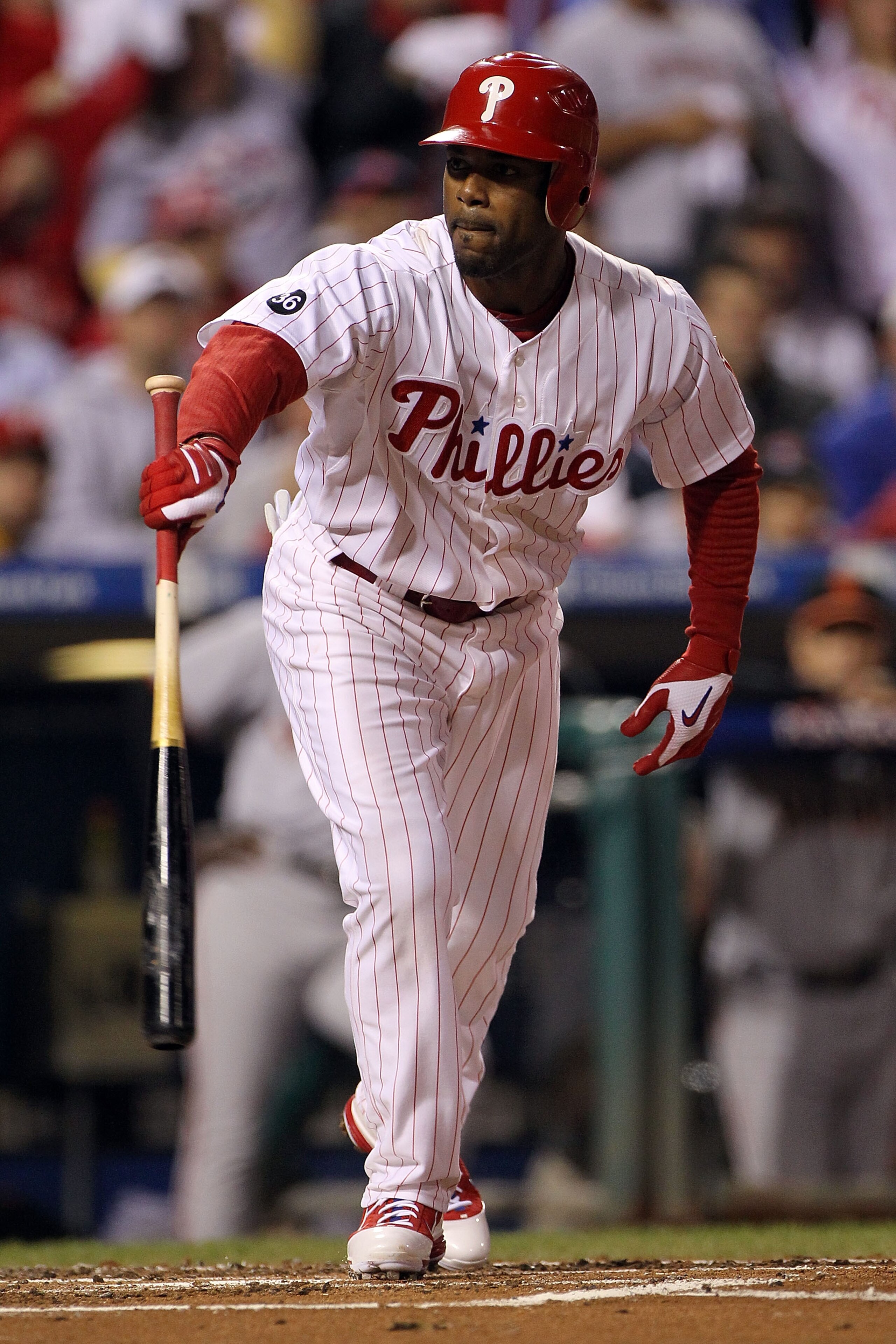 PHILADELPHIA - OCTOBER 17:  Jimmy Rollins #11 of the Philadelphia Phillies walks with the bases loaded to score Chase Utley #26 in the first inning against the San Francisco Giants in Game Two of the NLCS during the 2010 MLB Playoffs at Citizens Bank Park