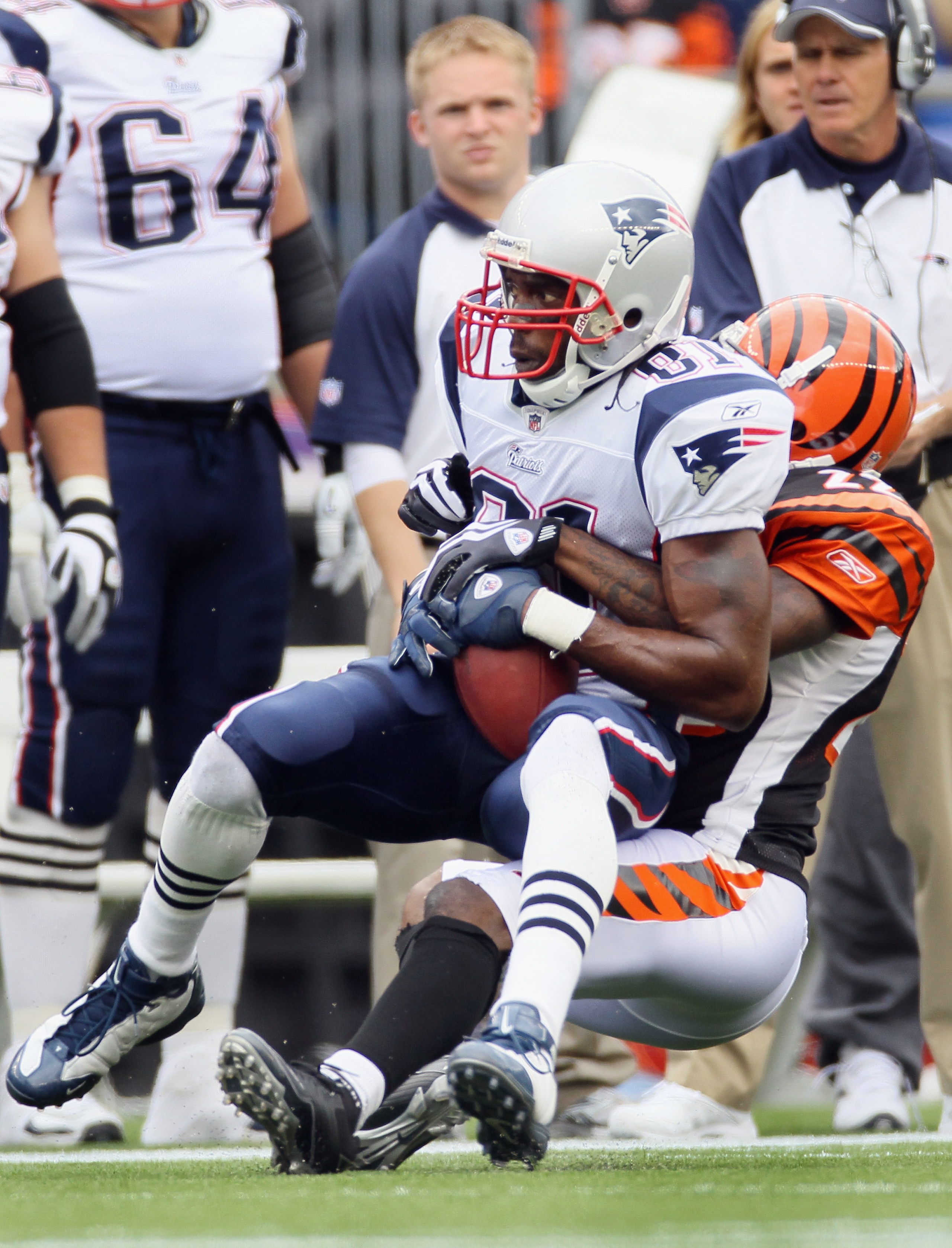 FOXBORO, MA - SEPTEMBER 12:  Randy Moss #81 of the New England Patriots catches a pass as Johnathan Joseph #22 of the Cincinnati Bengals makes the tackle during the NFL season opener on September 12, 2010 at Gillette Stadium in Foxboro, Massachusetts.  (P