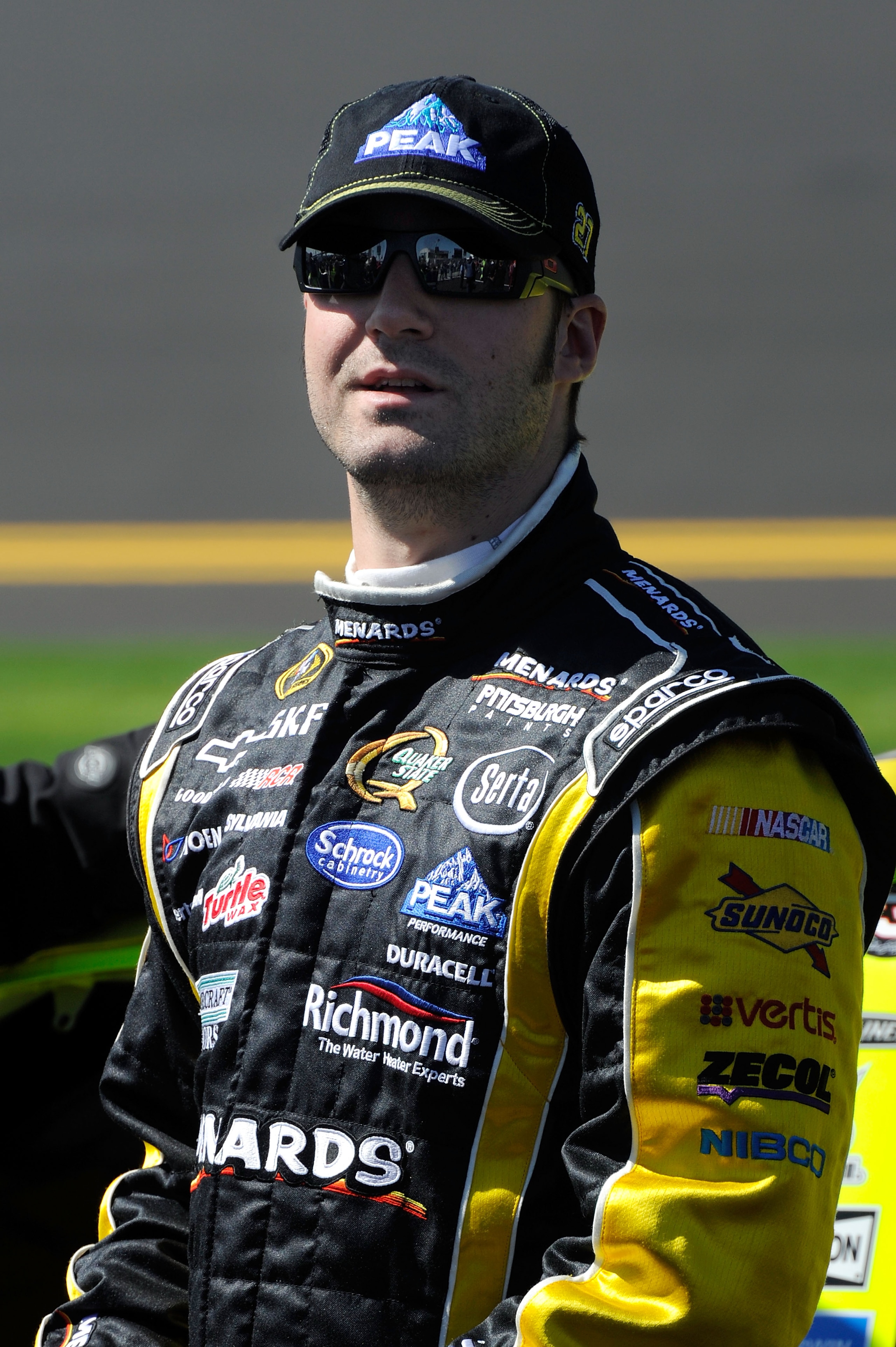 DAYTONA BEACH, FL - FEBRUARY 13:  Paul Menard, driver of the #27 Menards Chevrolet, stands on the grid during qualifying for the NASCAR Sprint Cup Series Daytona 500 at Daytona International Speedway on February 13, 2011 in Daytona Beach, Florida.  (Photo