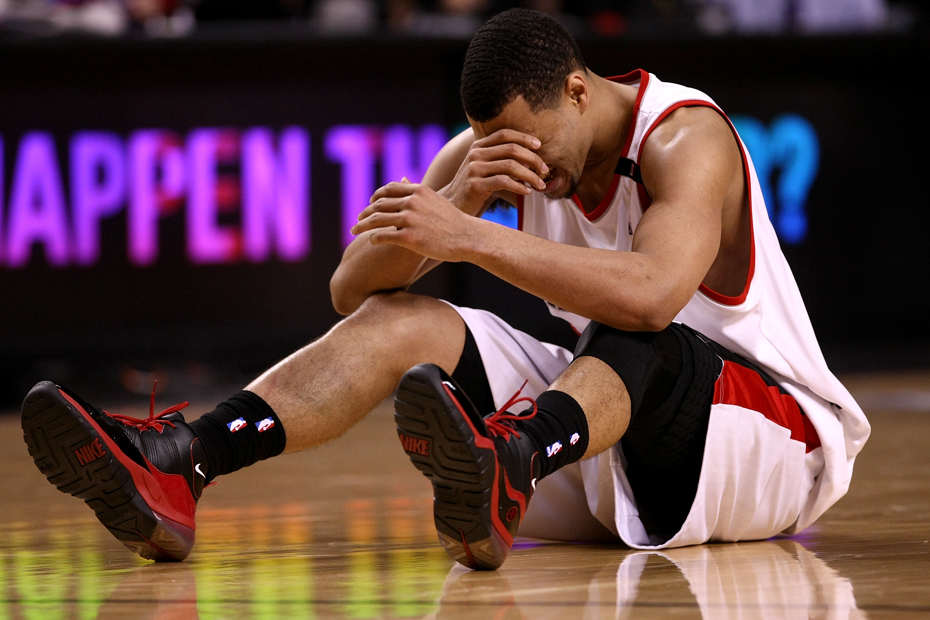 PORTLAND, OR - APRIL 18:  Brandon Roy #7 of the Portland Trail Blazers holds his face after being injured during a scramble for the ball against  the Houston Rockets during Game One of the Western Conference Quarterfinals of the 2009 NBA Playoffs on April