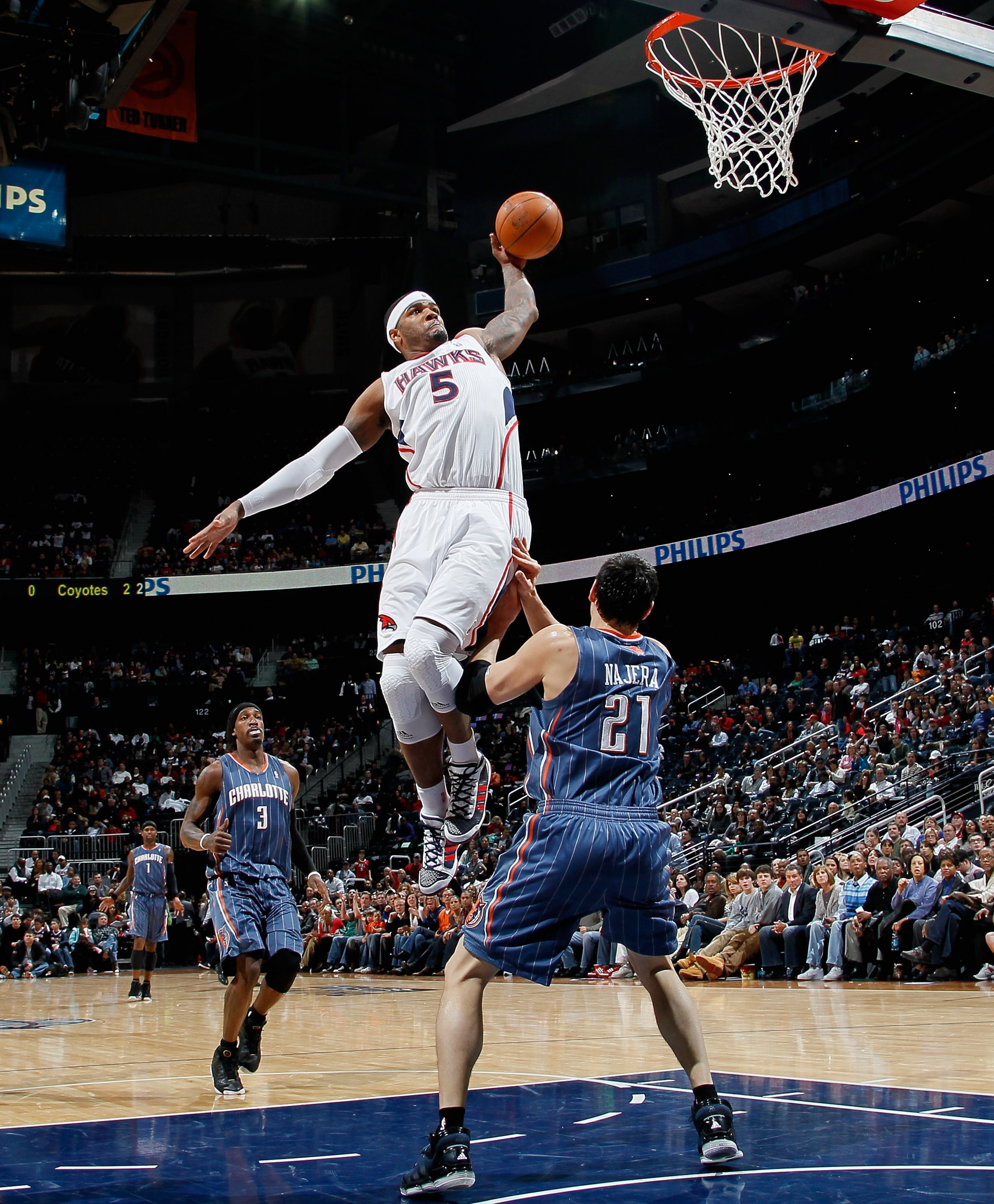 ATLANTA, GA - FEBRUARY 12:  Josh Smith #5 of the Atlanta Hawks dunks over Eduardo Najera #21 of the Charlotte Bobcats at Philips Arena on February 12, 2011 in Atlanta, Georgia.  NOTE TO USER: User expressly acknowledges and agrees that, by downloading and