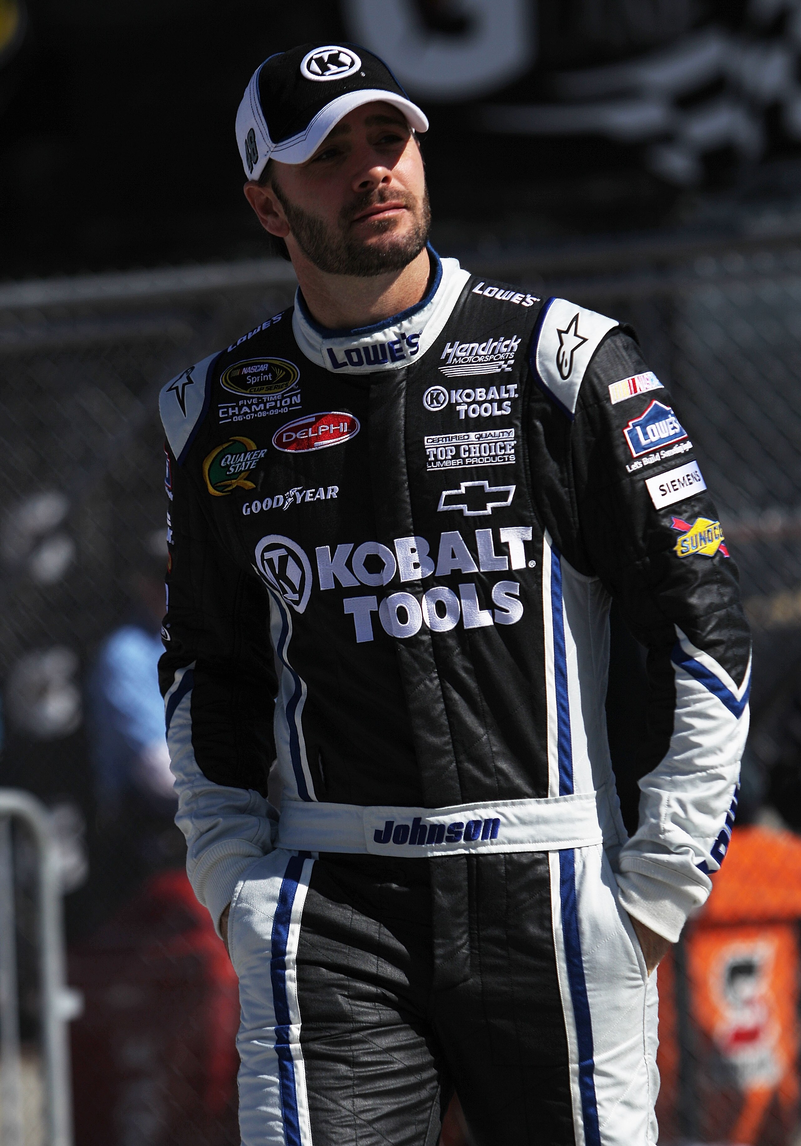 DAYTONA BEACH, FL - FEBRUARY 13:  Jimmie Johnson, driver of the #48 Lowe's Chevrolet, walks during qualifying for the NASCAR Sprint Cup Series Daytona 500 at Daytona International Speedway on February 13, 2011 in Daytona Beach, Florida.  (Photo by Nick La