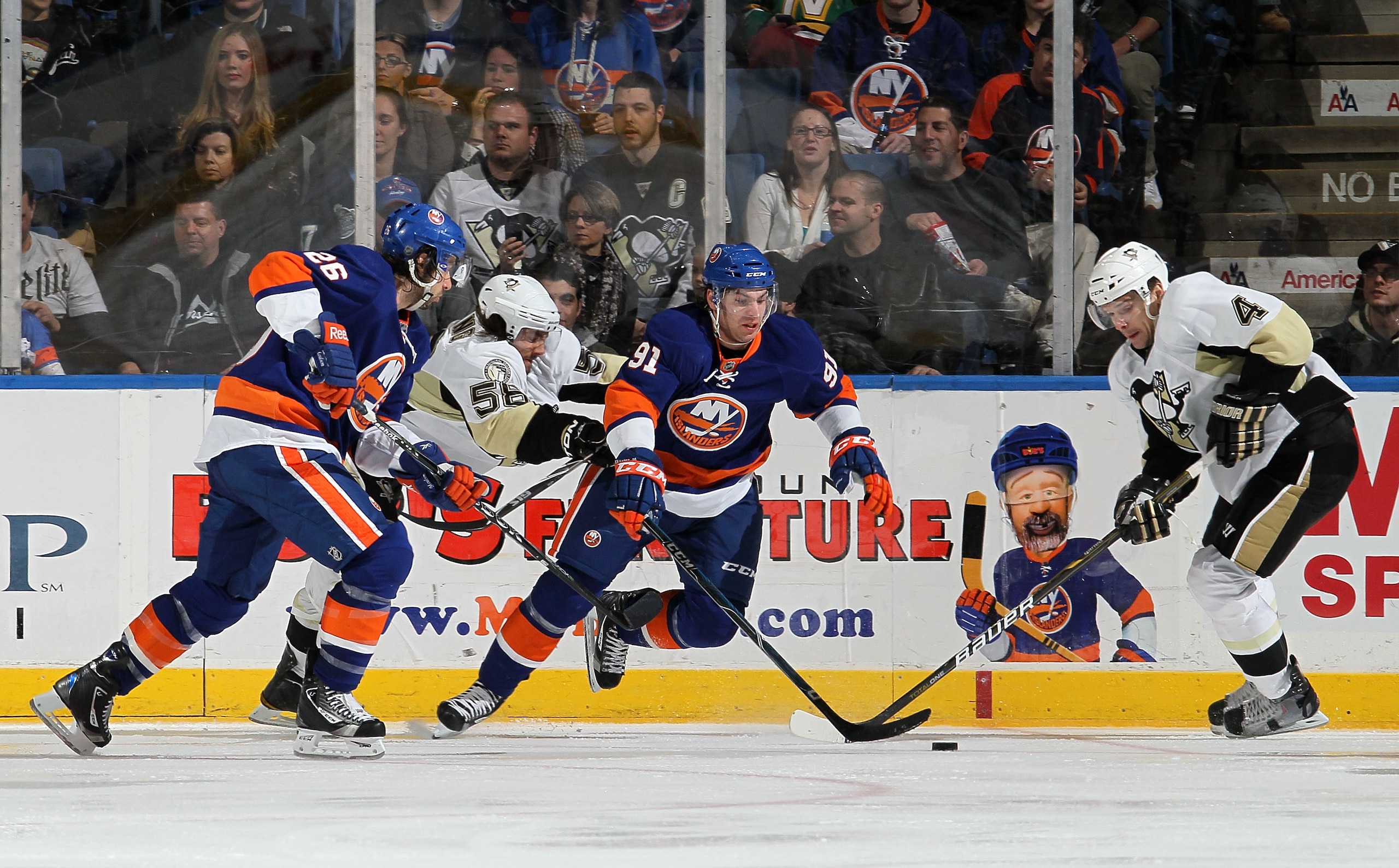UNIONDALE, NY - FEBRUARY 11:  John Tavares #91 and Matt Moulson #26 of the New York Islanders skate against Zbynek Michalek #4 and Kris Letang #58 of the Pittsburgh Penguins on February 11, 2011 at Nassau Coliseum in Uniondale, New York.  (Photo by Jim Mc