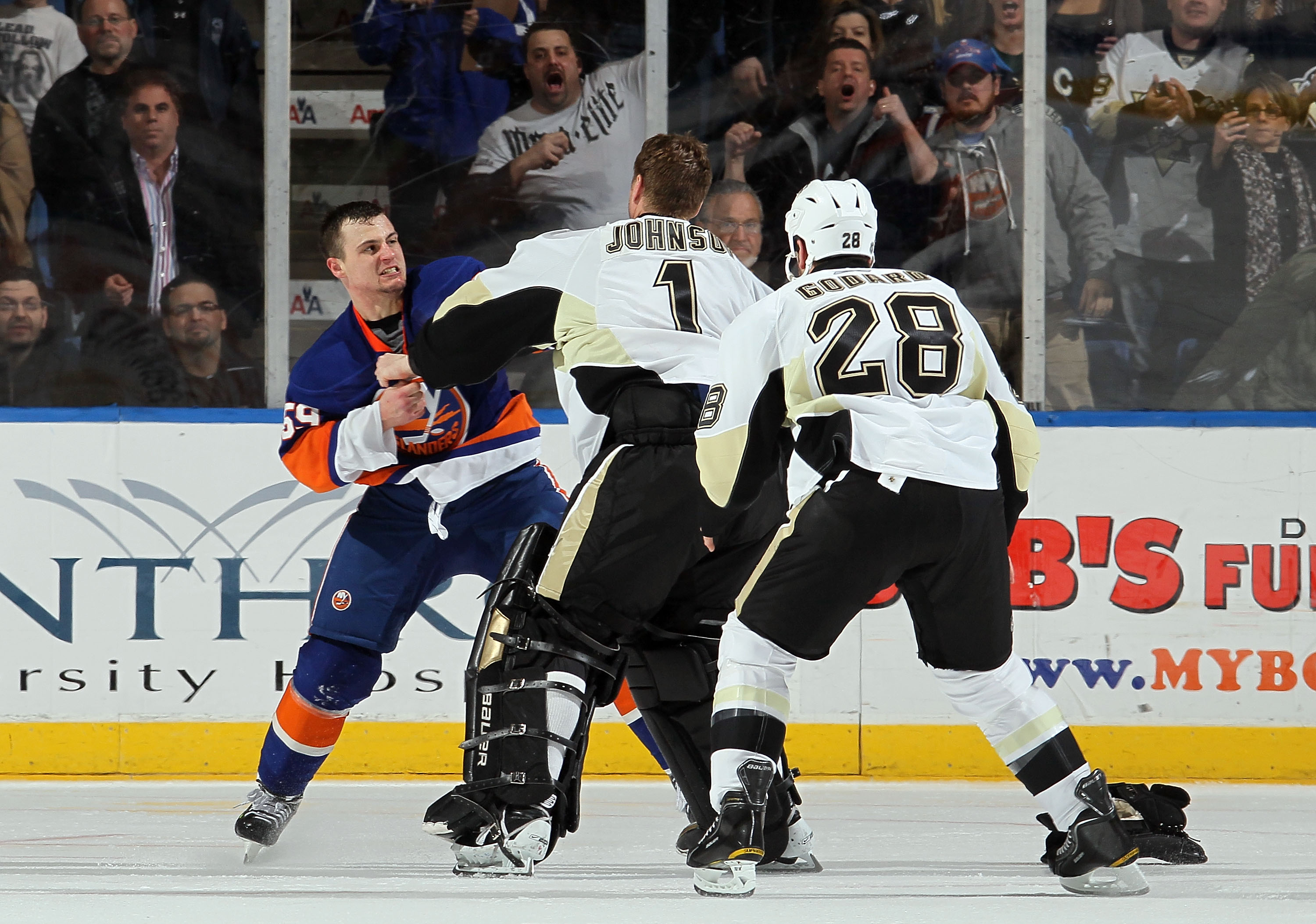 UNIONDALE, NY - FEBRUARY 11:  Micheal Haley #59 of the New York Islanders fights Brent Johnson #1 of the Pittsburgh Penguins in the third period on February 11, 2011 at Nassau Coliseum in Uniondale, New York. The Isles defeated the Pens 9-3.  (Photo by Ji