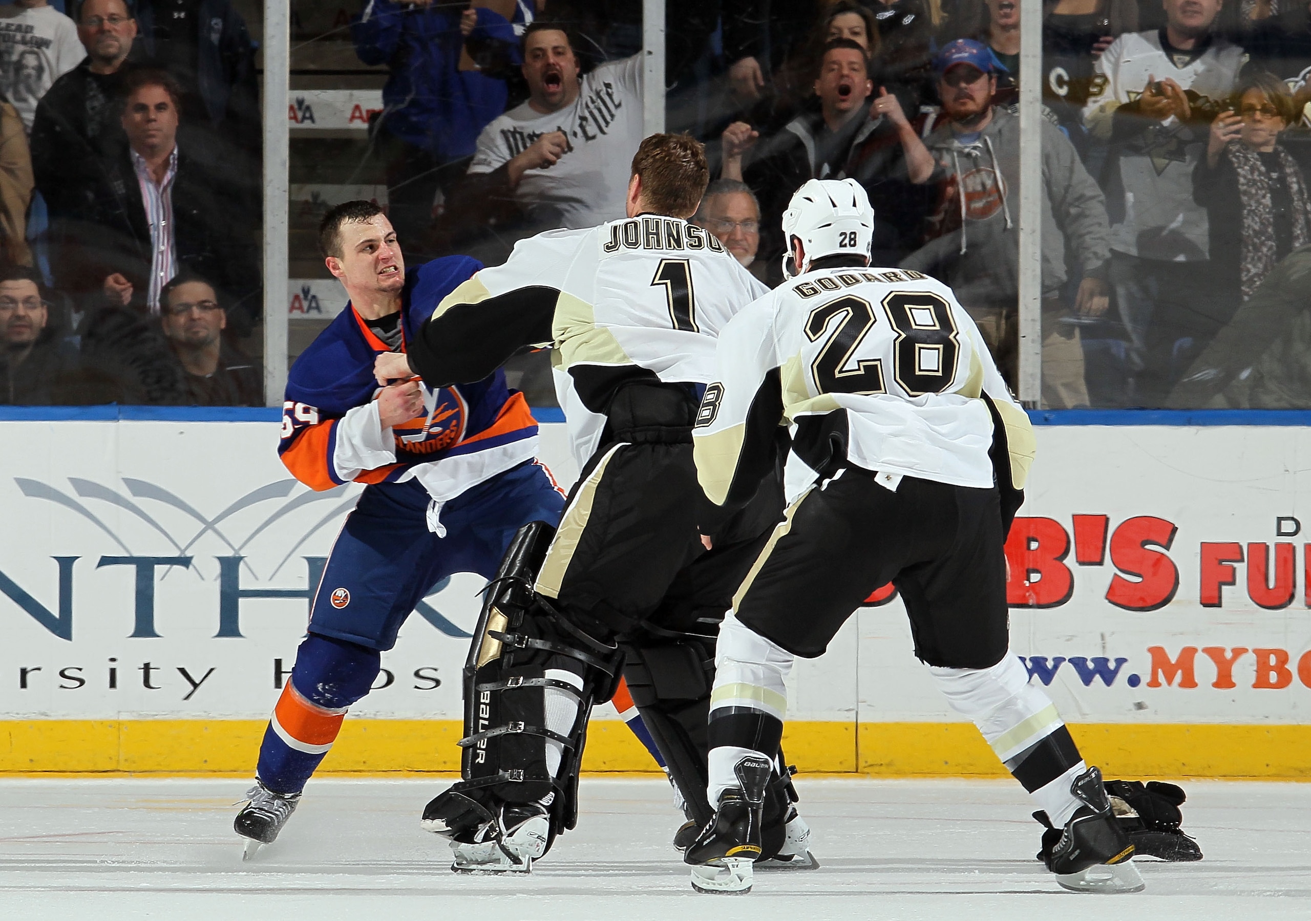 UNIONDALE, NY - FEBRUARY 11:  Micheal Haley #59 of the New York Islanders fights Brent Johnson #1 of the Pittsburgh Penguins in the third period on February 11, 2011 at Nassau Coliseum in Uniondale, New York. The Isles defeated the Pens 9-3.  (Photo by Ji