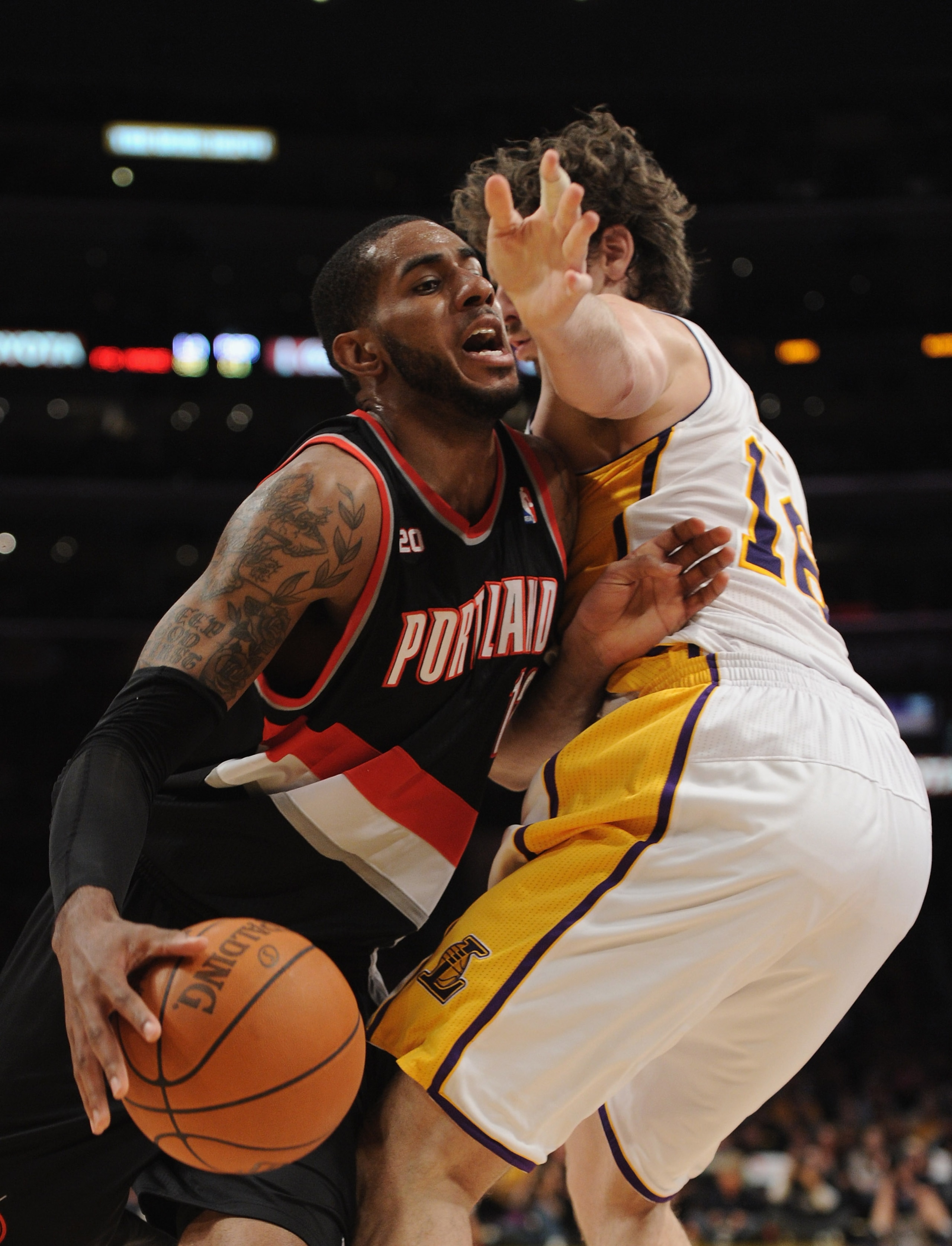 LOS ANGELES, CA - NOVEMBER 07:  LaMarcus Aldridge #12 of the Portland Trail Blazers takes a foul from Pau Gasol #12 of the Los Angeles Lakers during a 121-96 loss at the Staples Center on November 7, 2010 in Los Angeles, California.  NOTE TO USER: User ex