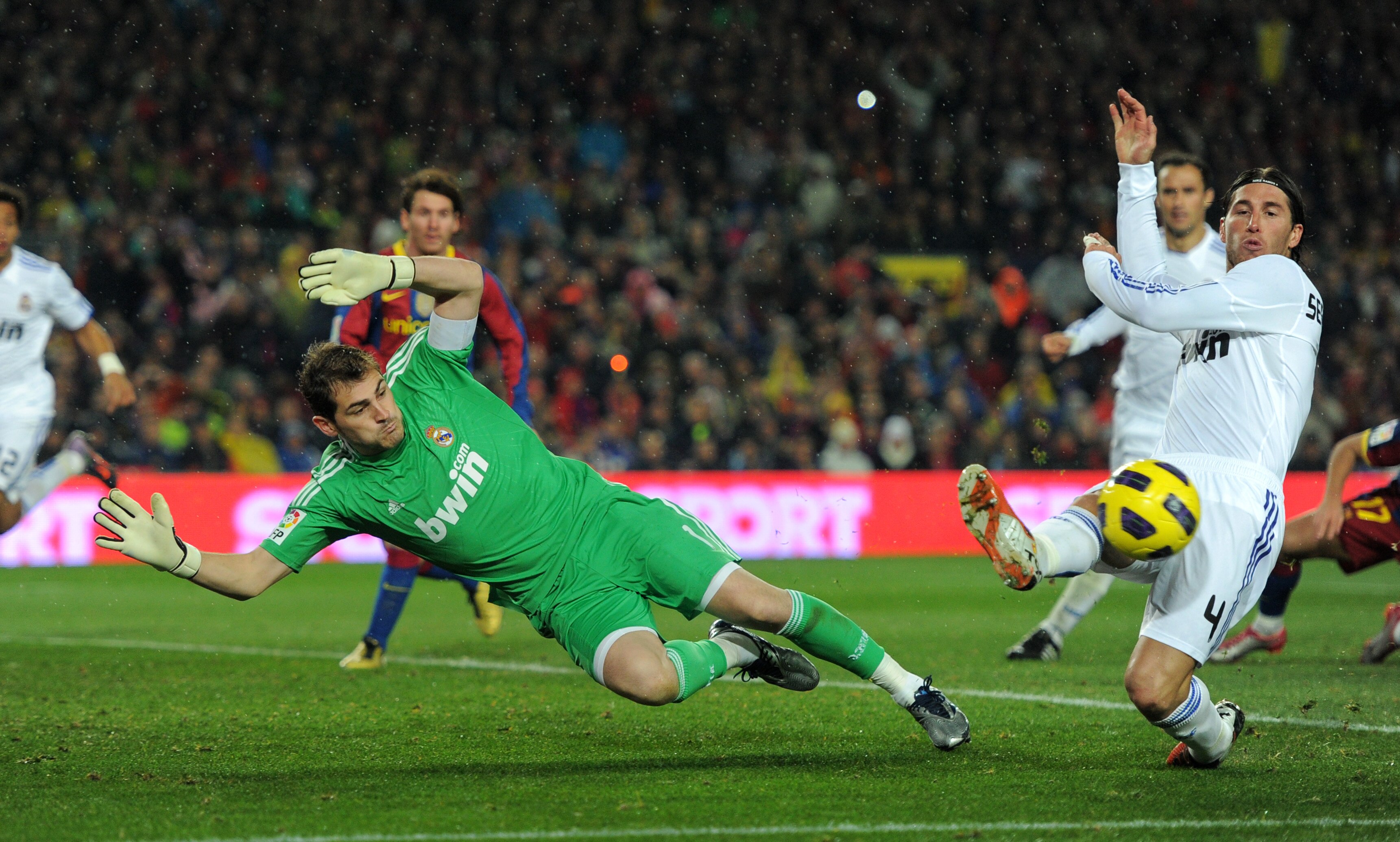 BARCELONA, SPAIN - NOVEMBER 29:  Goalkeeper Iker Casillas (L) of Real Madrid dives for a ball flanked by his teammate Sergio Ramos during the la liga match between Barcelona and Real Madrid at the Camp Nou stadium on November 29, 2010 in Barcelona, Spain.