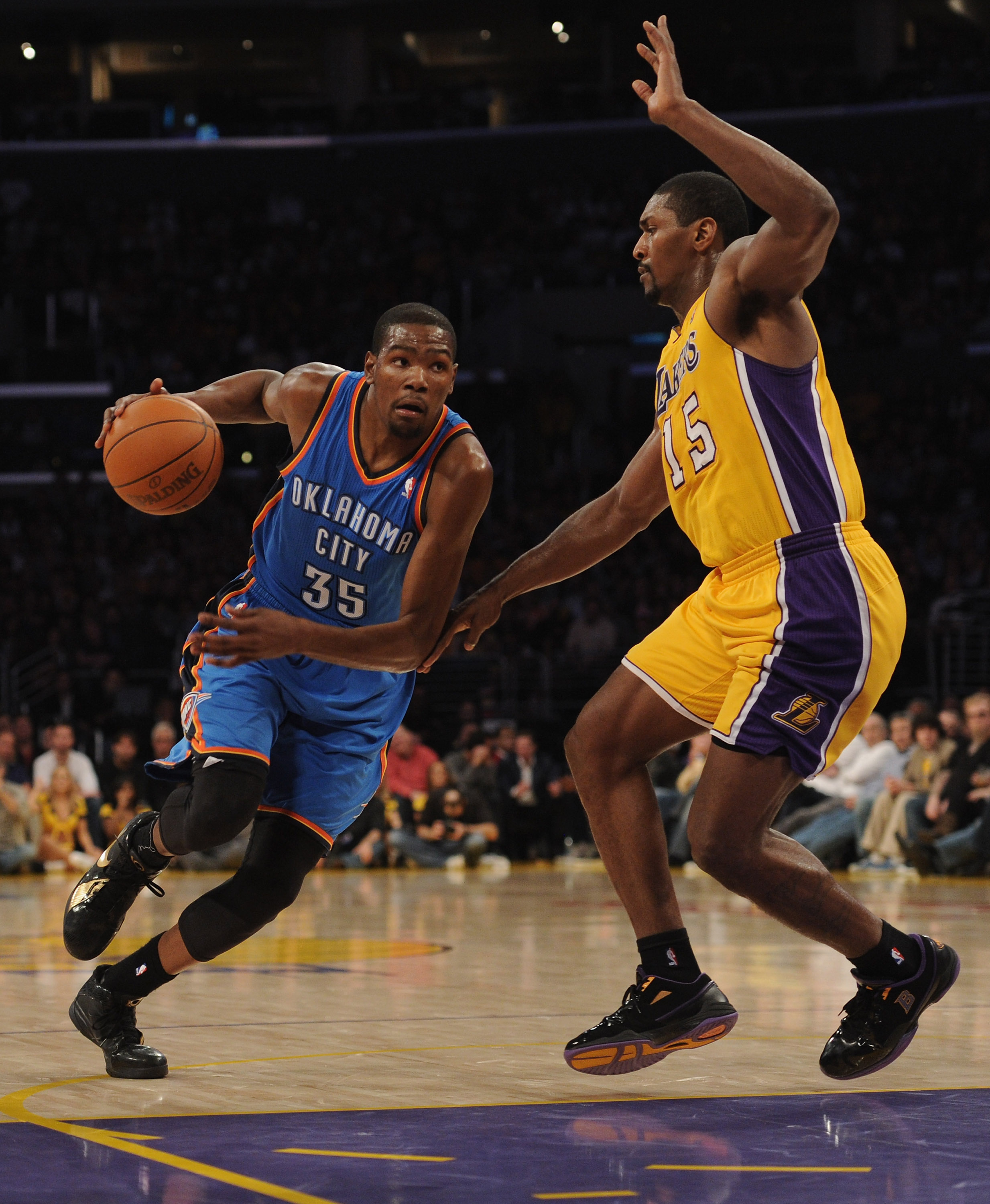 LOS ANGELES, CA - JANUARY 17:  Kevin Durant #35 of the Oklahoma City Thunder dribbles to the basket around Ron Artest #15 of the Los Angeles Lakers at the Staples Center on January 17, 2011 in Los Angeles, California.   NOTE TO USER: User expressly acknow