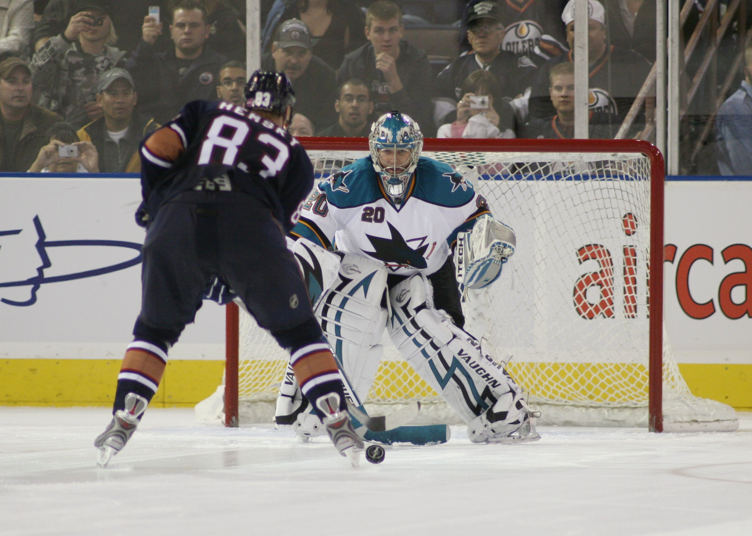 EDMONTON, AB - October 4:  Goaltender Evgeni Nabokov #20 of the San Jose Sharks looks to make a save on Ales Hemsky #83 of the Edmonton Oilers during the NHL game on October 4, 2007 at Rexall Place in Edmonton, Alberta, Canada.  (Photo by Tim Smith/Getty