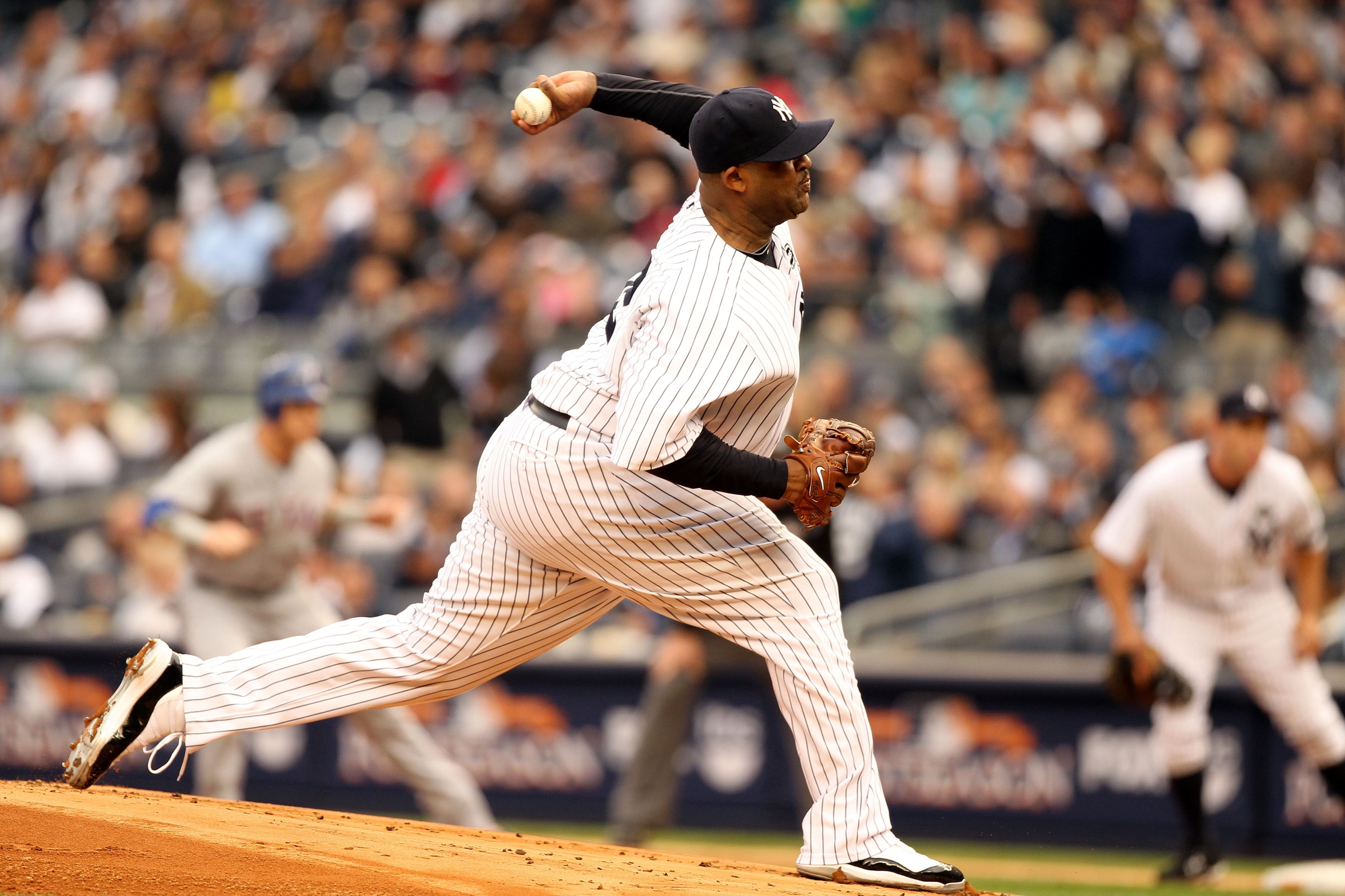 NEW YORK - OCTOBER 20:  CC Sabathia #52 of the New York Yankees pitches against the Texas Rangers in Game Five of the ALCS during the 2010 MLB Playoffs at Yankee Stadium on October 20, 2010 in the Bronx borough of New York City.  (Photo by Al Bello/Getty
