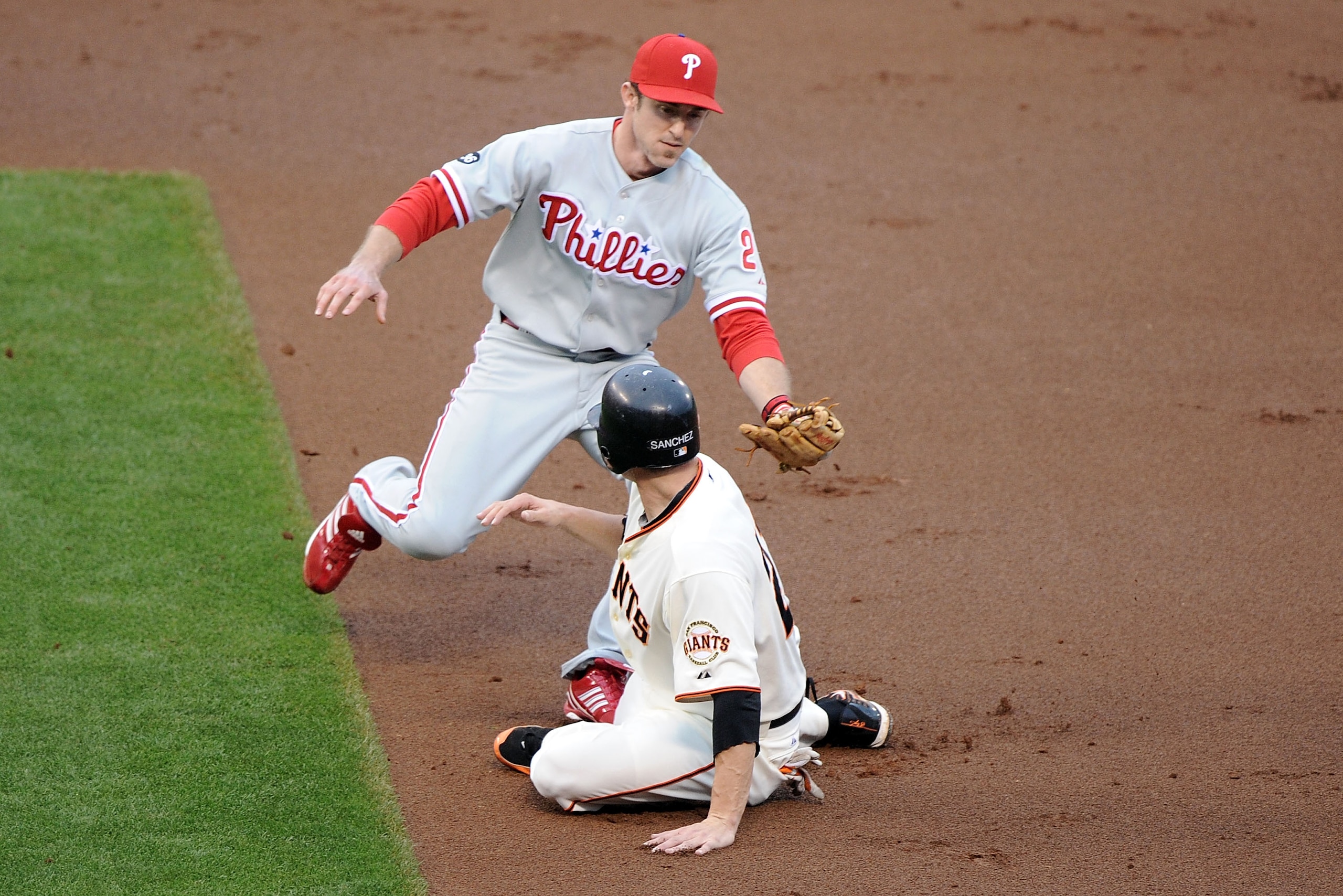 SAN FRANCISCO - OCTOBER 21:  Chase Utley #26 of the Philadelphia Phillies tags out Freddy Sanchez #21 of the San Francisco Giants in the first inning of Game Five of the NLCS during the 2010 MLB Playoffs at AT&T Park on October 21, 2010 in San Francisco,