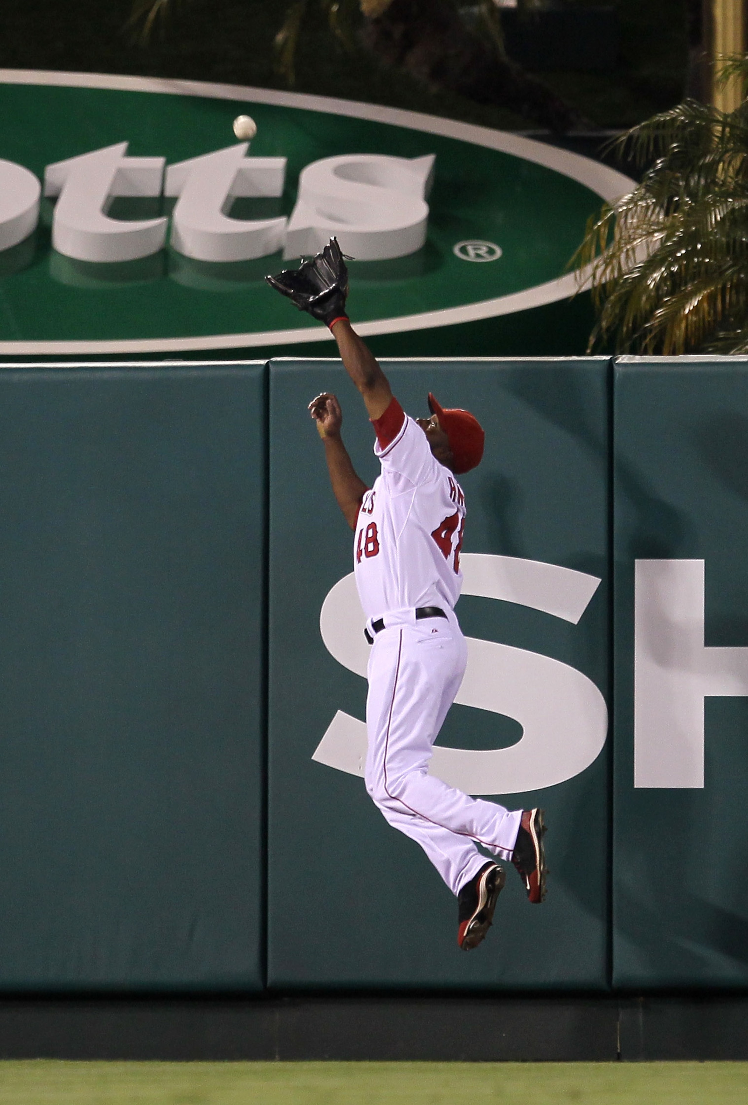 ANAHEIM, CA - JULY 27:  Center fielder Torii Hunter #48 of the Los Angeles Angels of Anaheim jumps to take a home run away from Mike Cameron of the Boston Red Sox for the final out of the eighth inning on July 27, 2010 at Angel Stadium in Anaheim, Califor