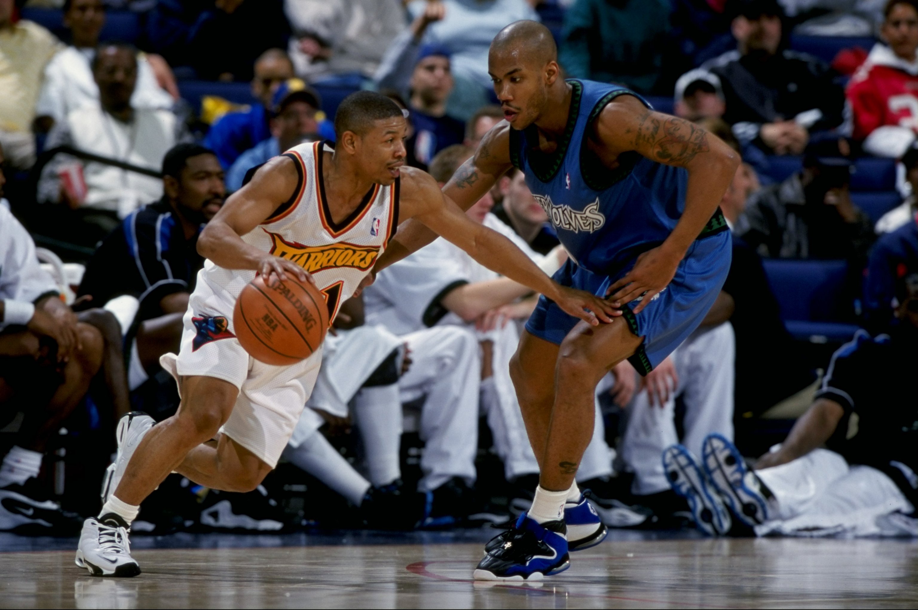 15 Feb 1999:  Stephon Marbury #3 of the Minnesota Timberwolves  tries to keep with Tyrone Bogues #1 during the game against the Golden State Warriors at the Oakland Arena in Oakland, California. The Warriors defeated the Timberwolves 101-99.  Mandatory Cr