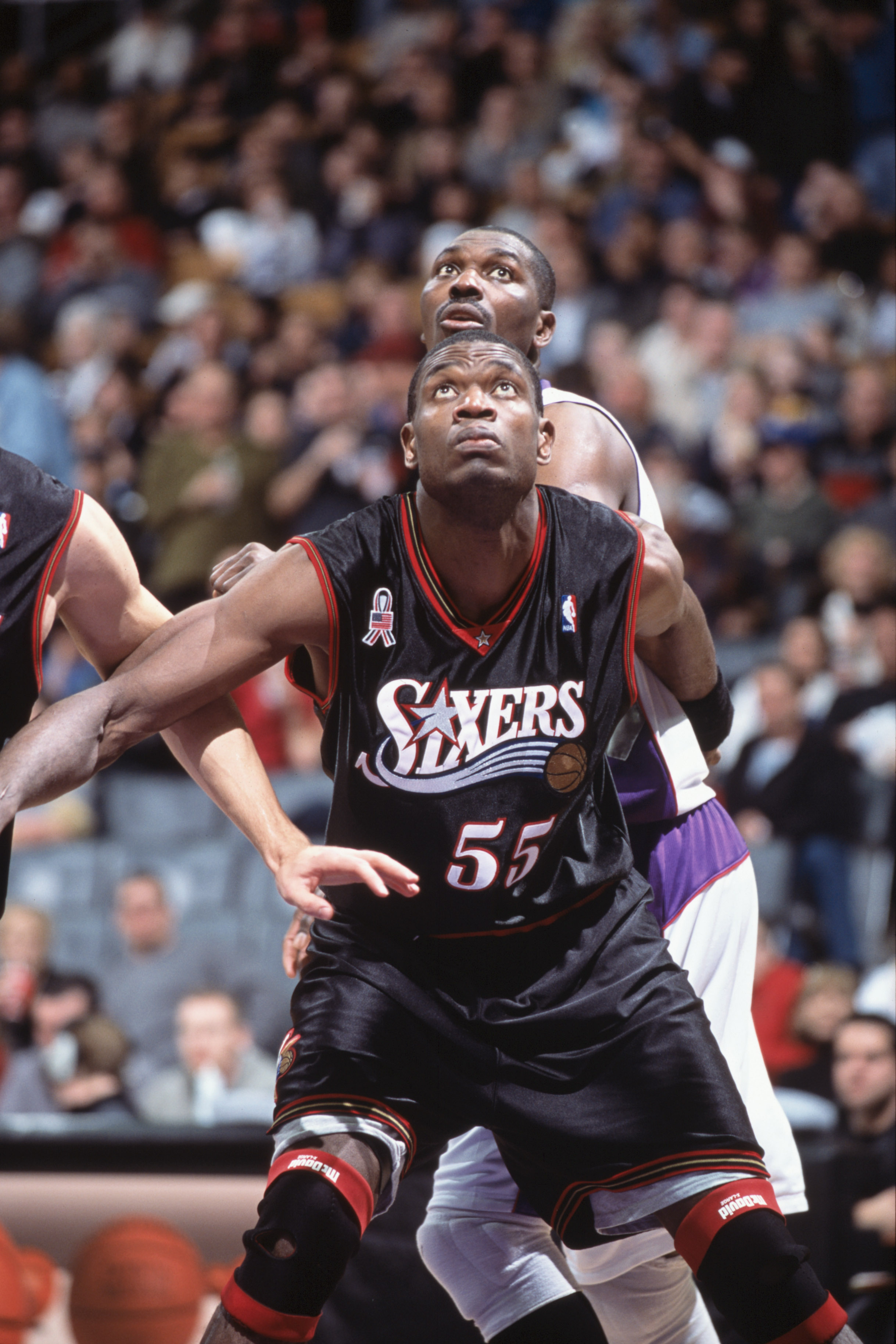 25 Nov 2001:  Dikembe Mutombo #55 of the Philadelphia 76ers blocks Hakeen Olajuwon #34 of the Toronto Raptors during the game at the Air Canada Centre in Toronto, Canada. The Raptors defeated the 76ers 107-88. TO USER: User expressly acknowledges and agre