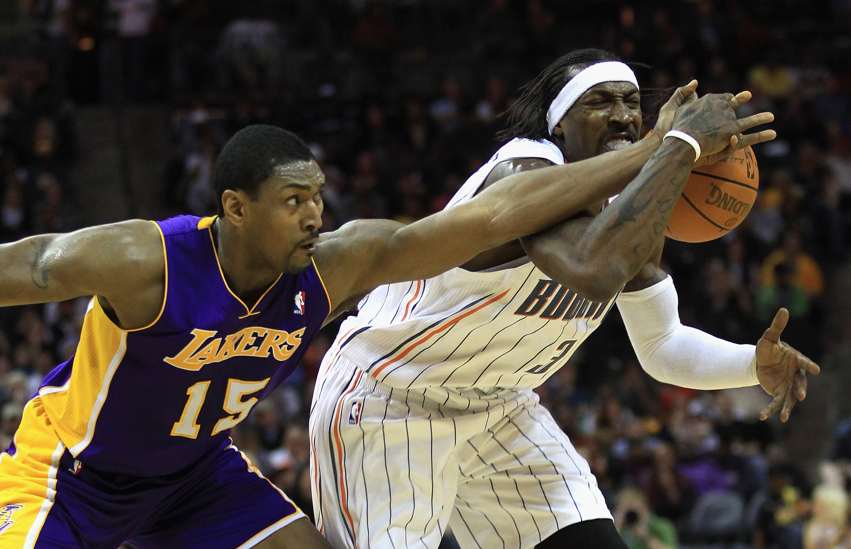 CHARLOTTE, NC - FEBRUARY 14:  Ron Artest #15 of the Los Angeles Lakers knocks the ball loose from Gerald Wallace #3 of the Charlotte Bobcats during their game at Time Warner Cable Arena on February 14, 2011 in Charlotte, North Carolina. NOTE TO USER: User