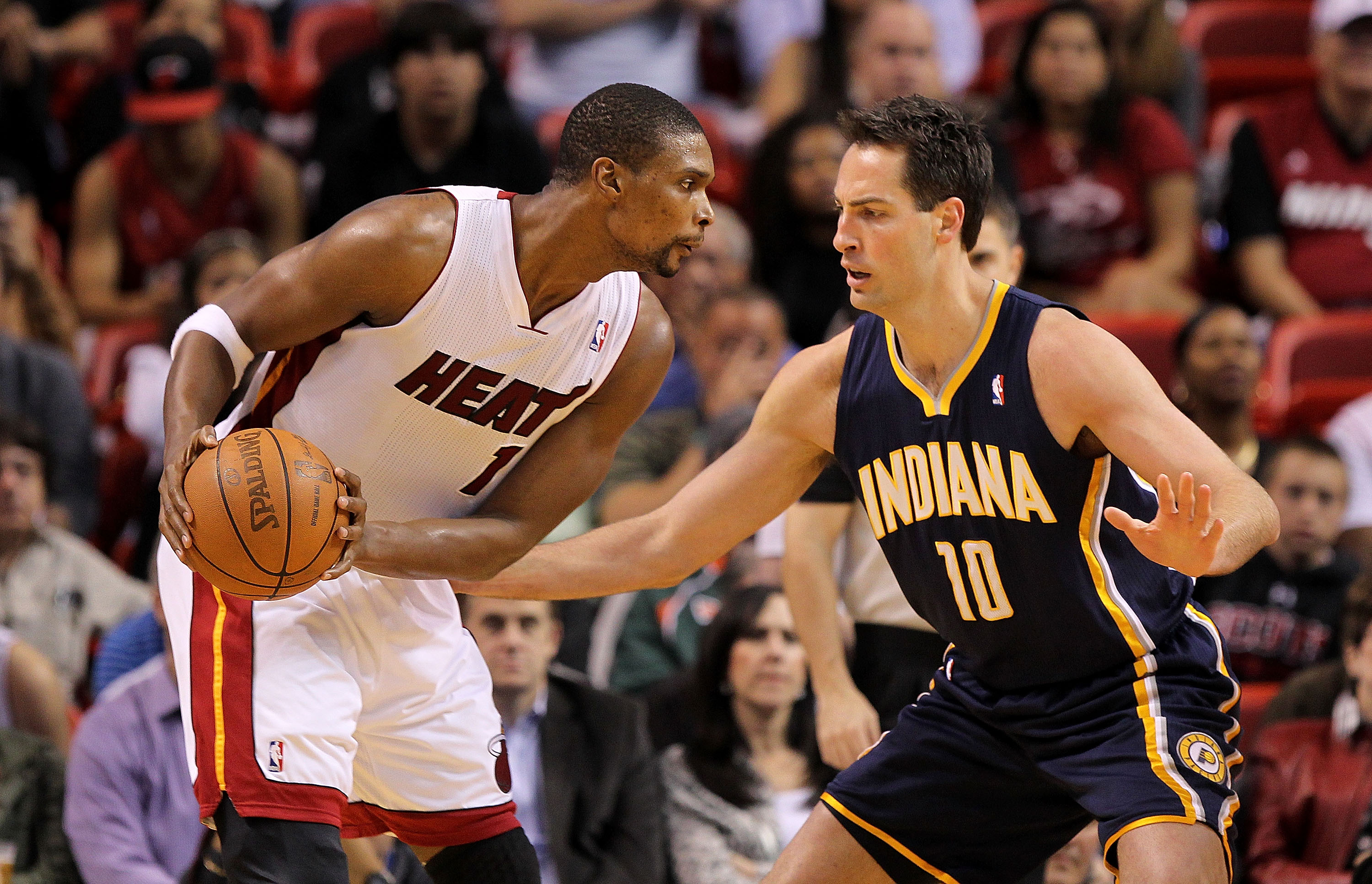 MIAMI, FL - FEBRUARY 08:  Chris Bosh #1 of the Miami Heat is guarded by Jeff Foster #10 of the Indiana Pacers during a game at American Airlines Arena on February 8, 2011 in Miami, Florida. NOTE TO USER: User expressly acknowledges and agrees that, by dow