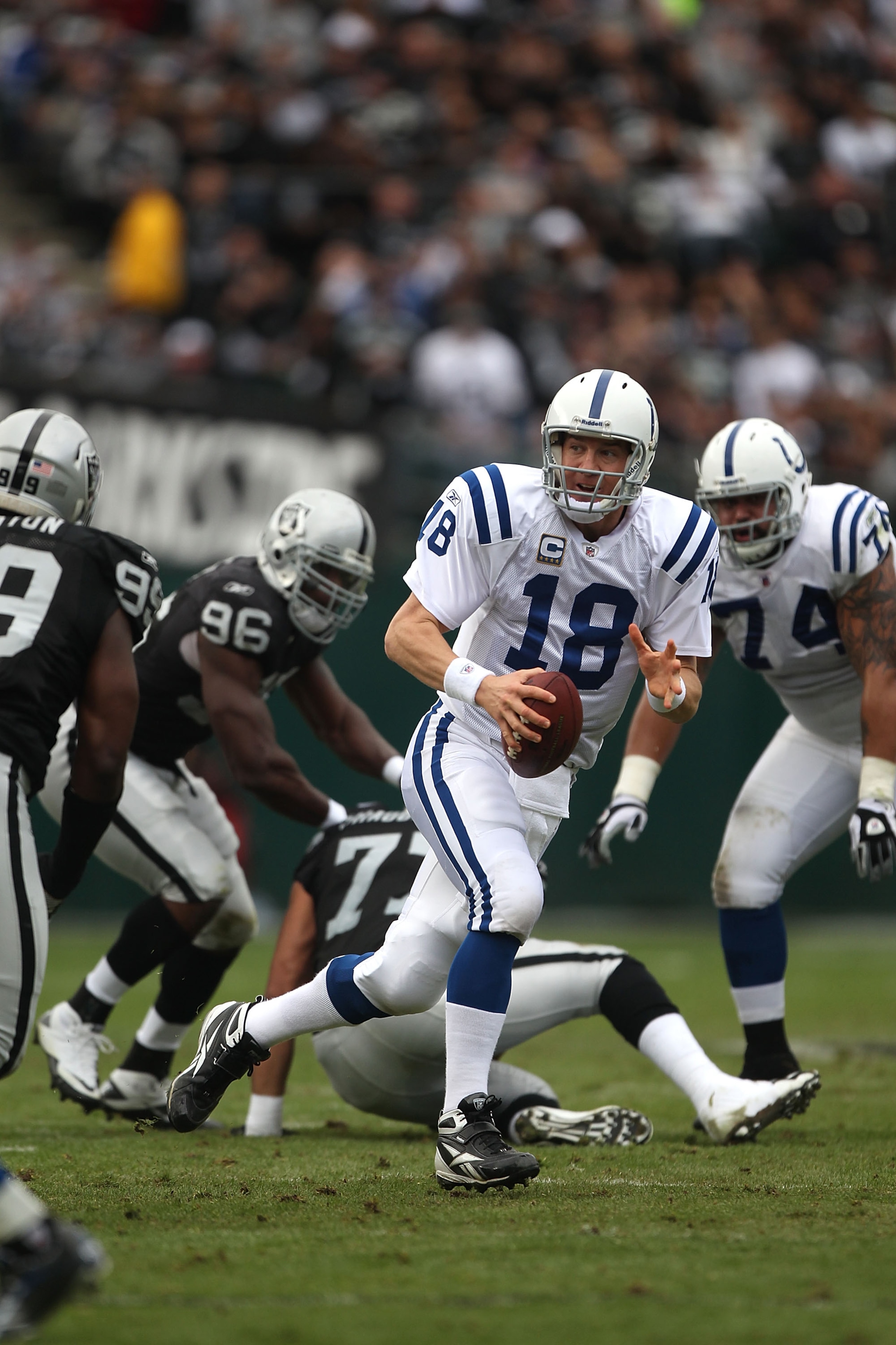 OAKLAND, CA - DECEMBER 26:  Peyton Manning #18 of the Indianapolis Colts runs with the ball against the Oakland Raiders during an NFL game at Oakland-Alameda County Coliseum on December  26, 2010 in Oakland, California.  (Photo by Jed Jacobsohn/Getty Imag