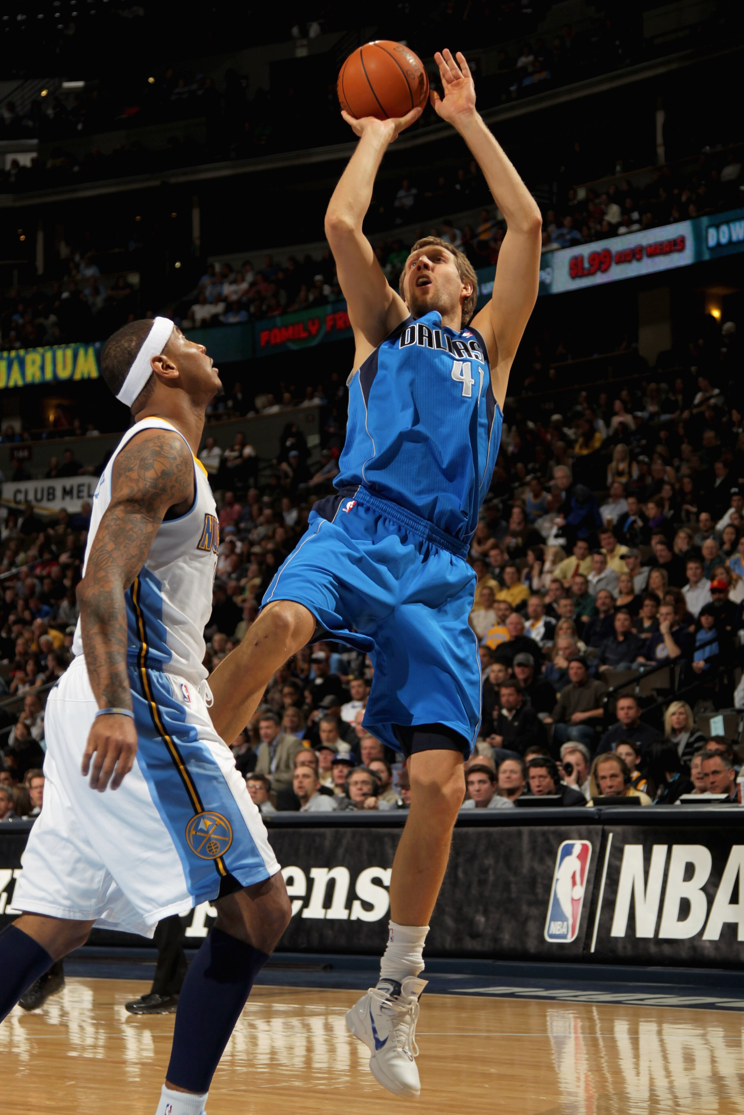DENVER, CO - FEBRUARY 10: Dirk Nowitzki #41 of the Dallas Mavericks takes a shot over Carmelo Anthony #15 of the Denver Nuggets during NBA action at the Pepsi Center on February 10, 2011 in Denver, Colorado. NOTE TO USER: User expressly acknowledges and DENVER, CO - FEBRUARY 10: Dirk Nowitzki #41 of the Dallas Mavericks takes a shot over Carmelo Anthony #15 of the Denver Nuggets during NBA action at the Pepsi Center on February 10, 2011 in Denver, Colorado. NOTE TO USER: User expressly acknowledges and