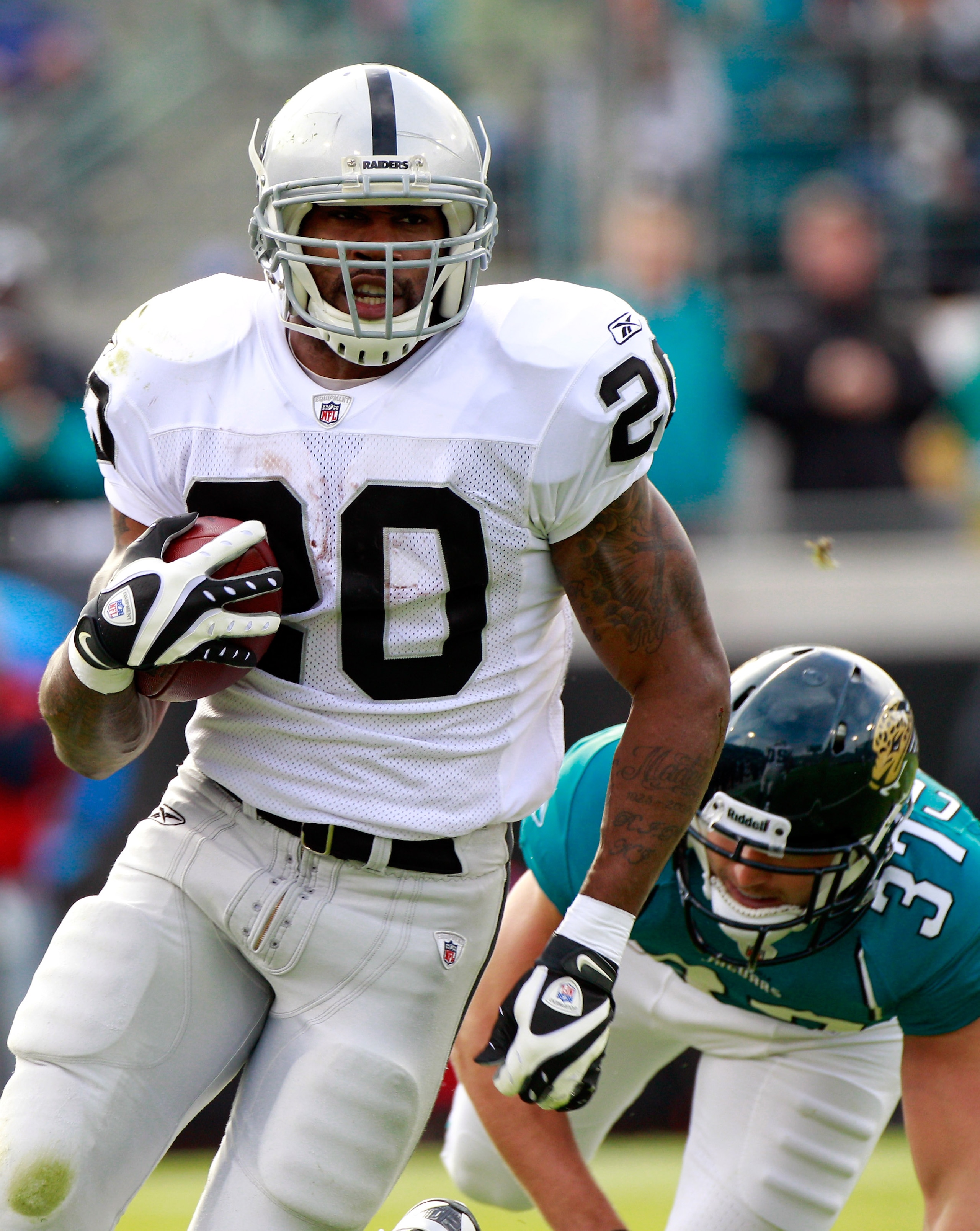 JACKSONVILLE, FL - DECEMBER 12: Sean Considine #37 of the Jacksonville Jaguars attempts to tackle Darren McFadden #20 of the Oakland Raiders during the game at EverBank Field on December 12, 2010 in Jacksonville, Florida. (Photo by Sam Greenwood/Getty I JACKSONVILLE, FL - DECEMBER 12: Sean Considine #37 of the Jacksonville Jaguars attempts to tackle Darren McFadden #20 of the Oakland Raiders during the game at EverBank Field on December 12, 2010 in Jacksonville, Florida. (Photo by Sam Greenwood/Getty I