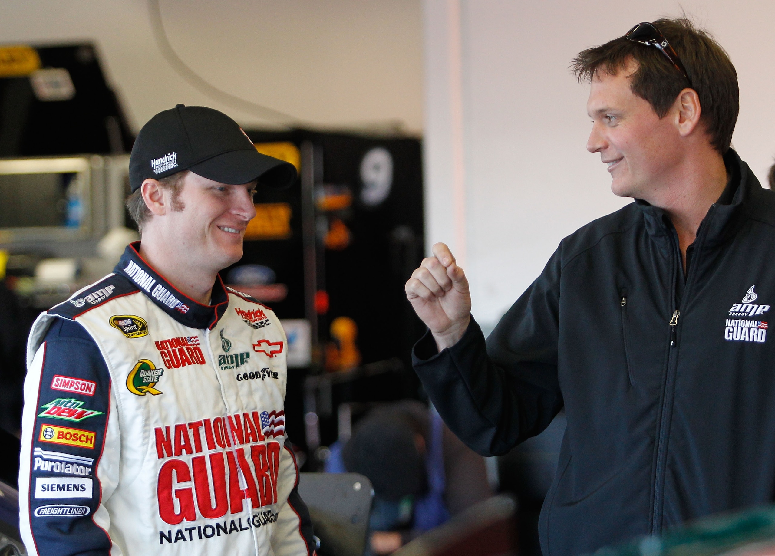 DAYTONA BEACH, FL - FEBRUARY 11:  (L-R) Dale Earnhardt Jr., driver of the #88 National Guard Chevrolet, stands in the garage area with crew chief Steve Letarte during practice for the NASCAR Budweiser Shootout at Daytona International Speedway on February