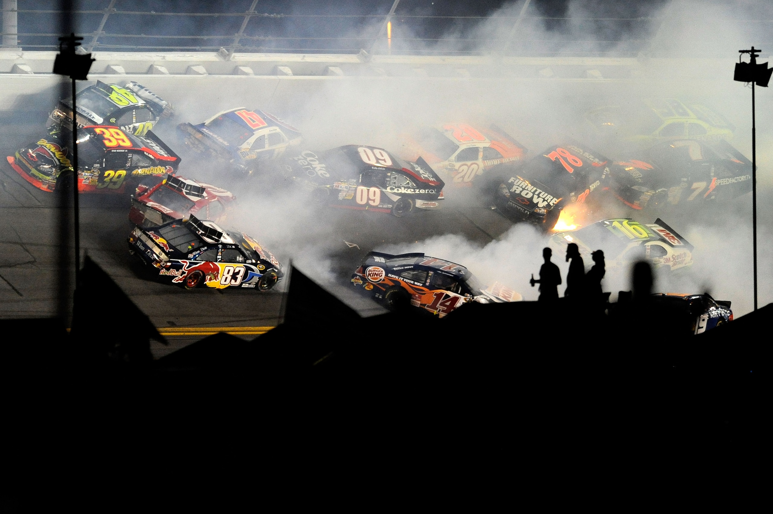 DAYTONA BEACH, FL - JULY 03:  A crash takes place on lap 148 during the NASCAR Sprint Cup Series Coke Zero 400 at Daytona International Speedway on July 3, 2010 in Daytona Beach, Florida.  (Photo by John Harrelson/Getty Images for NASCAR)