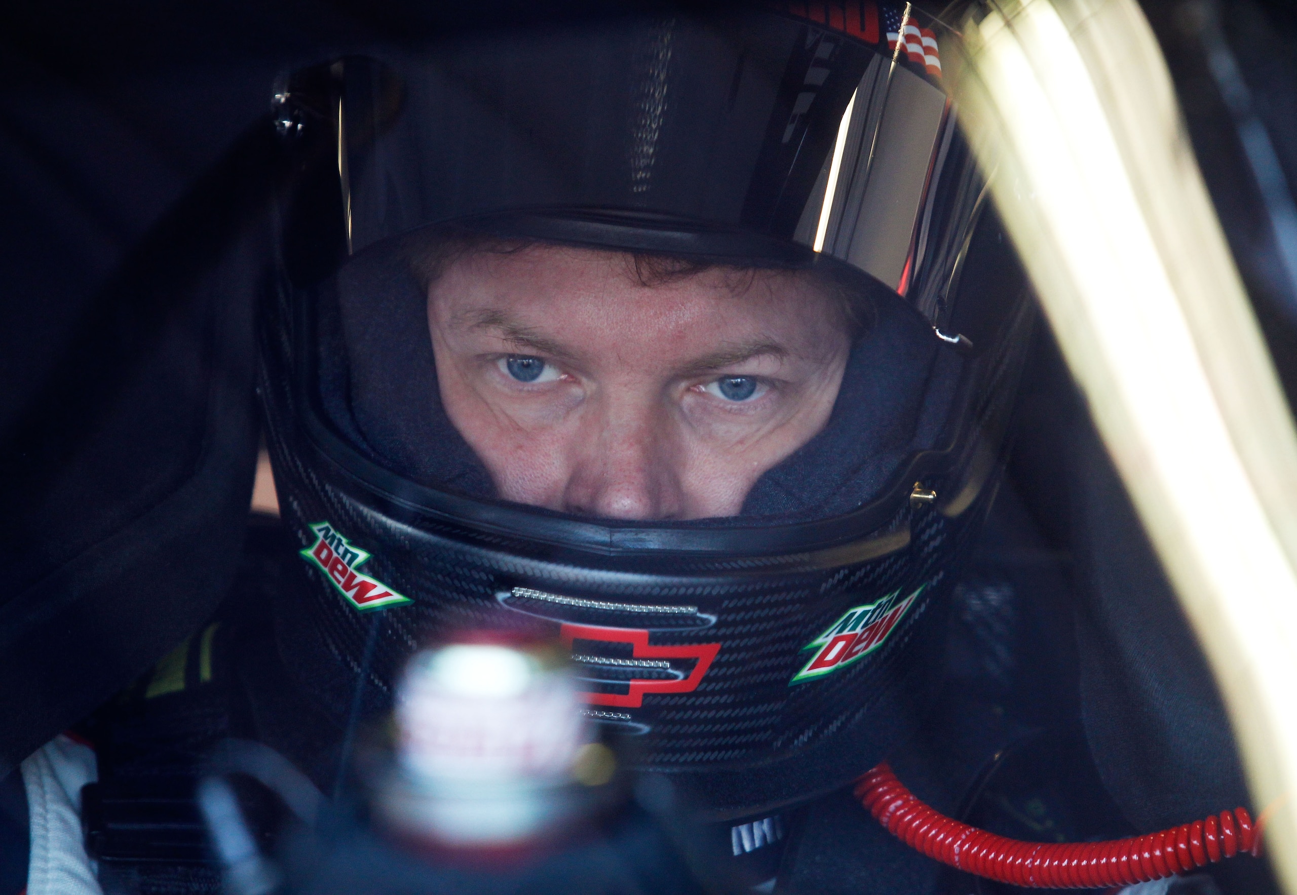DAYTONA BEACH, FL - FEBRUARY 11:  Dale Earnhardt Jr., driver of the #88 National Guard Chevrolet, sits in his car in the garage during practice for the NASCAR Budweiser Shootout at Daytona International Speedway on February 11, 2011 in Daytona Beach, Flor