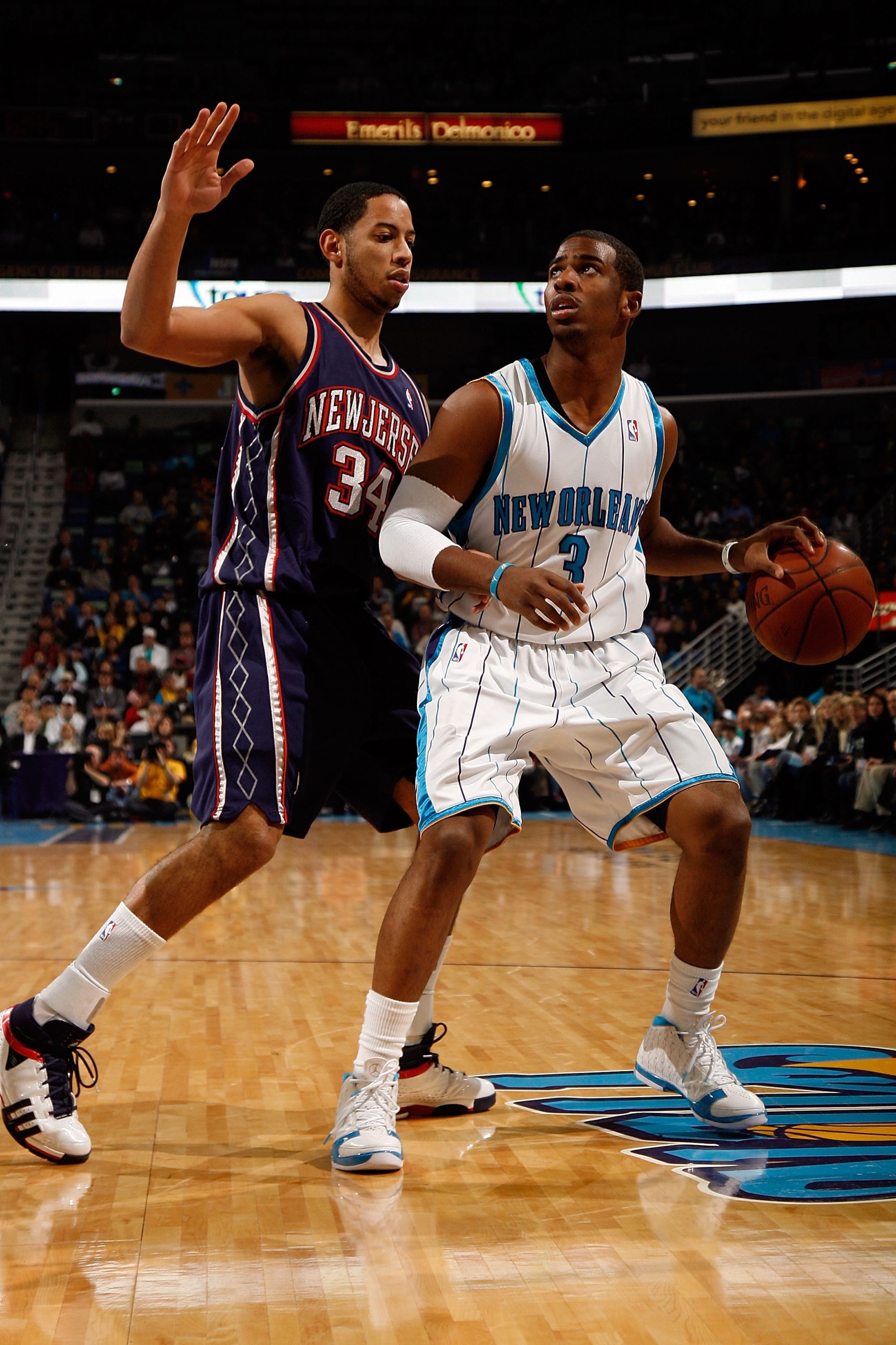 NEW ORLEANS - JANUARY 21:  Chris Paul #3 of the New Orleans Hornets drives the ball around Devin Harris #34 of the New Jersey Nets on January 21, 2009 at the New Orleans Arena in New Orleans, Louisiana.  NOTE TO USER: User expressly acknowledges and agree