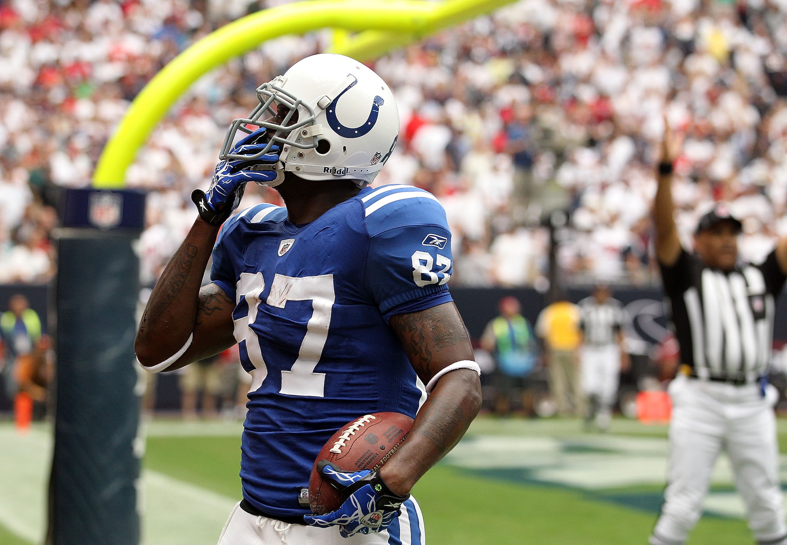 HOUSTON - SEPTEMBER 12:  Wide receiver Reggie Wayne #87 of the Indianapolis Colts celebrates his touchdown against the Houston Texans during the NFL season opener at Reliant Stadium on September 12, 2010 in Houston, Texas.  (Photo by Ronald Martinez/Getty