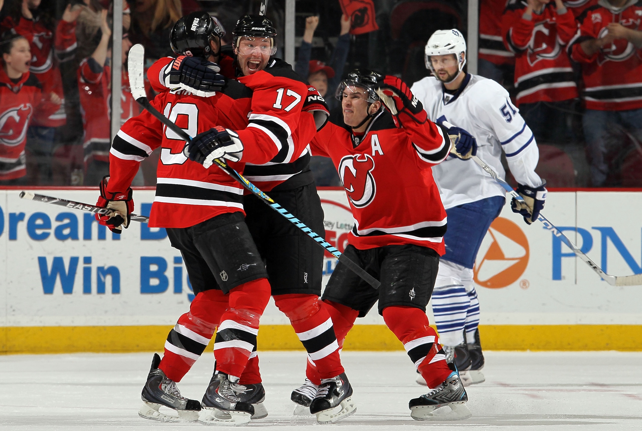 NEWARK, NJ - FEBRUARY 05:  Travis Zajac #19 of the New Jersey Devils celebrates his game tying goal in the third period against the Toronto Maple Leafs with teammtes Ilya Kovalchuk #17 and Zach Parise #9 at the Prudential Center on February 5, 2010 in New