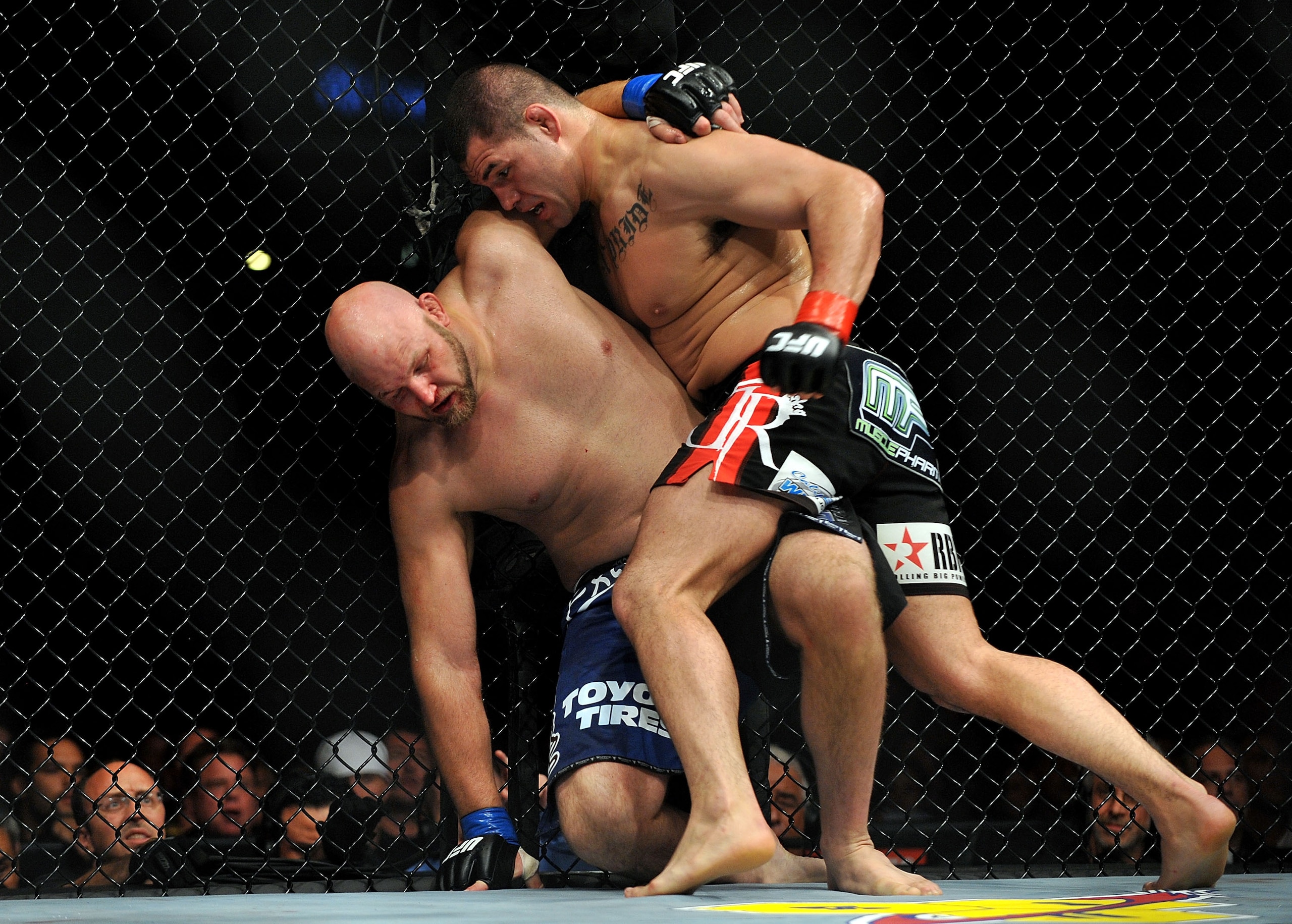 LOS ANGELES, CA - OCTOBER 24:  UFC fighter Cain Velasquez (R) hits UFC fighter Ben Rothwell (L) up against the fence during their Heavyweight bout at UFC 104: Machida vs. Shogun at Staples Center on October 24, 2009 in Los Angeles, California.  Velasquez 