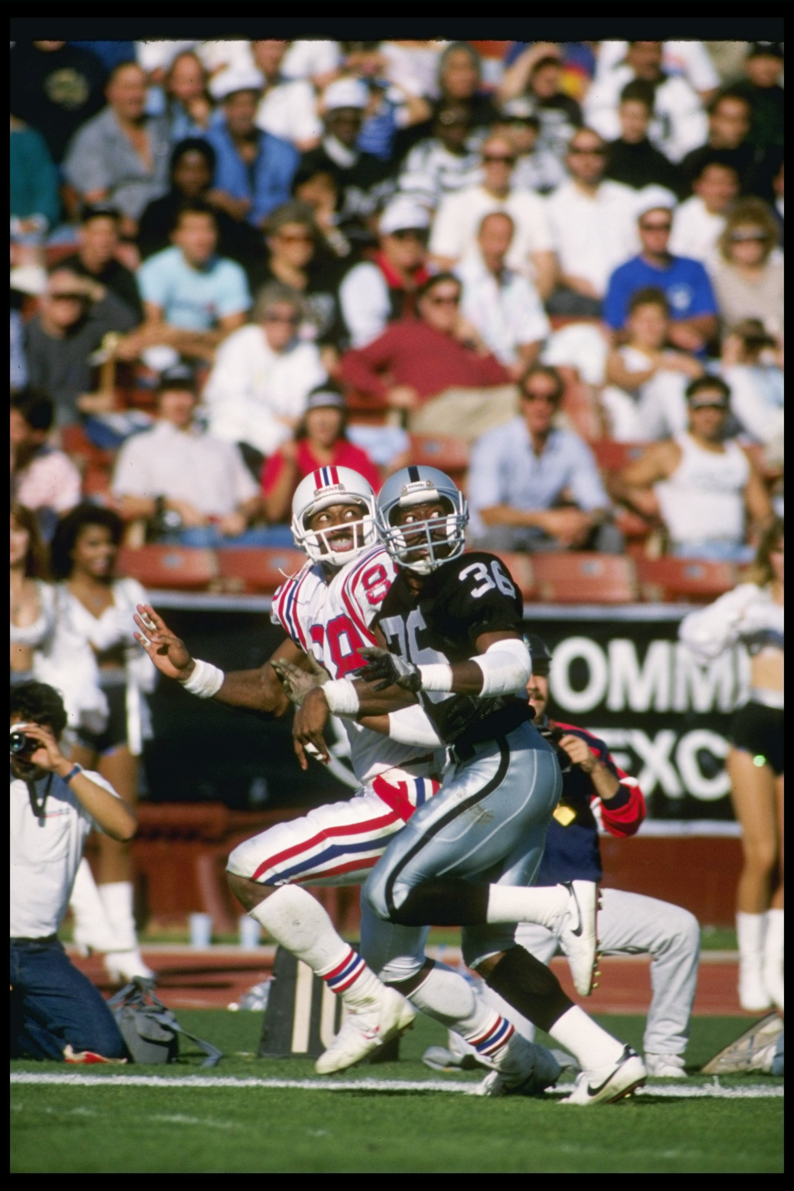 26 Nov 1989:  Defensive back Terry McDaniel of the Los Angeles Raiders (right) and New England Patriots wide receiver Hart Lee Dykes look for the ball during a game at the Los Angeles Memorial Coliseum in Los Angeles, California.  The Raiders won the game