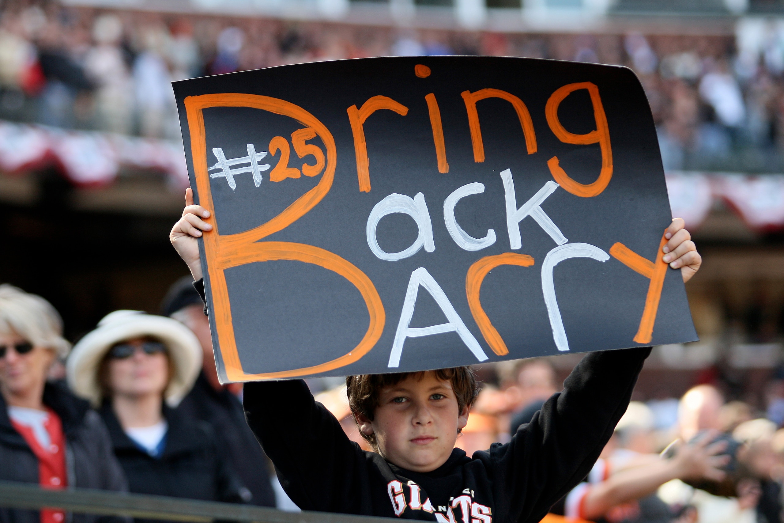 SAN FRANCISCO - APRIL 7:  A young San Francisco Giants fan holds a sign imploring the Giants to Bring Back Barry (Bonds) during the opening day game against the San Diego Padres on April 7, 2008 at AT&T Park in San Francisco, California. The Padres defeat