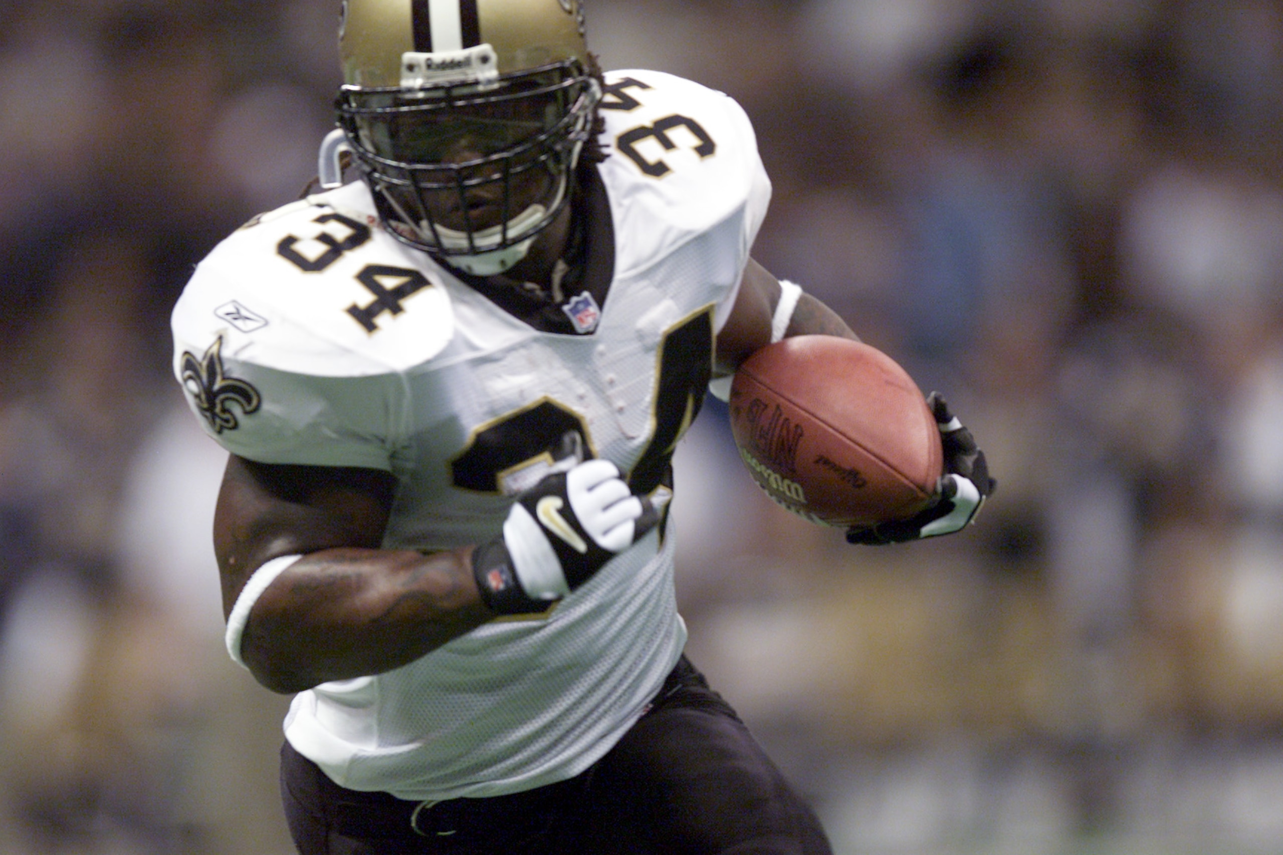 17 Dec 2001: Ricky Williams of the New Orleans Saints gains yardage against the St.Louis Rams during the game at Louisiana Superdome in New Orleans, Louisiana. The Rams won 34-21. DIGITAL IMAGE. Mandatory Credit: Craig Jones/Getty Images