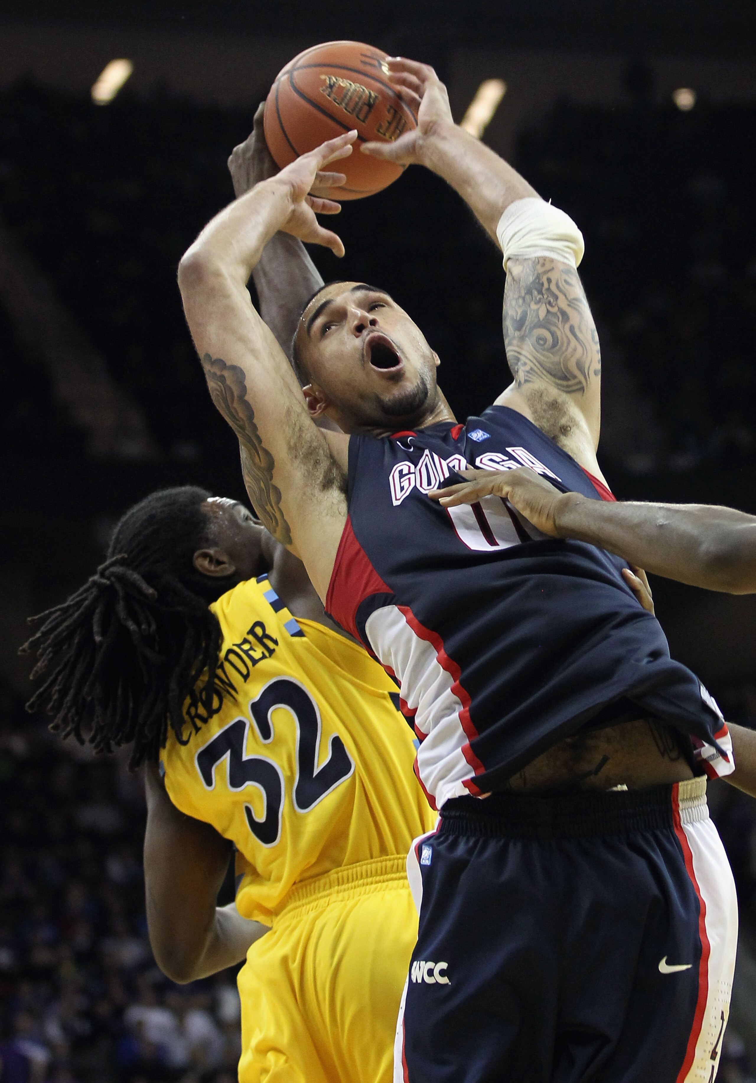 KANSAS CITY, MO - NOVEMBER 23:  Robert Sacre #00 of the Gonzaga Bulldogs grabs a rebound over Jae Crowder #32 of the Marquette Golden Eagles during the CBE Classic consolation game on November 23, 2010 at the Sprint Center in Kansas City, Missouri.  (Phot