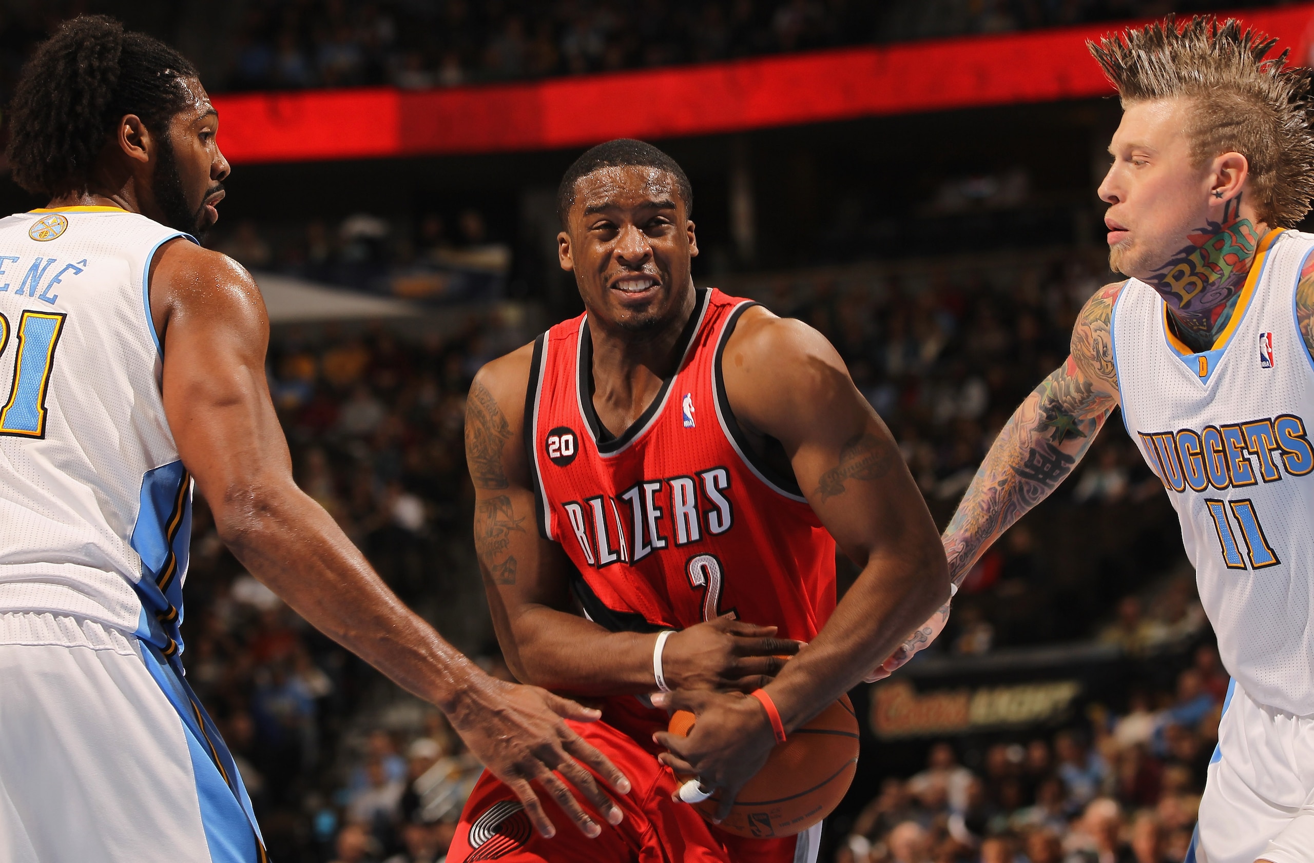 DENVER - DECEMBER 28:  Wesley Matthews #2 of the Portland Trail Blazers tries to hang onto the ball as he drives between Nene #31 and Chris Andersen #11 of the Denver Nuggets at Pepsi Center on December 28, 2010 in Denver, Colorado. NOTE TO USER: User exp