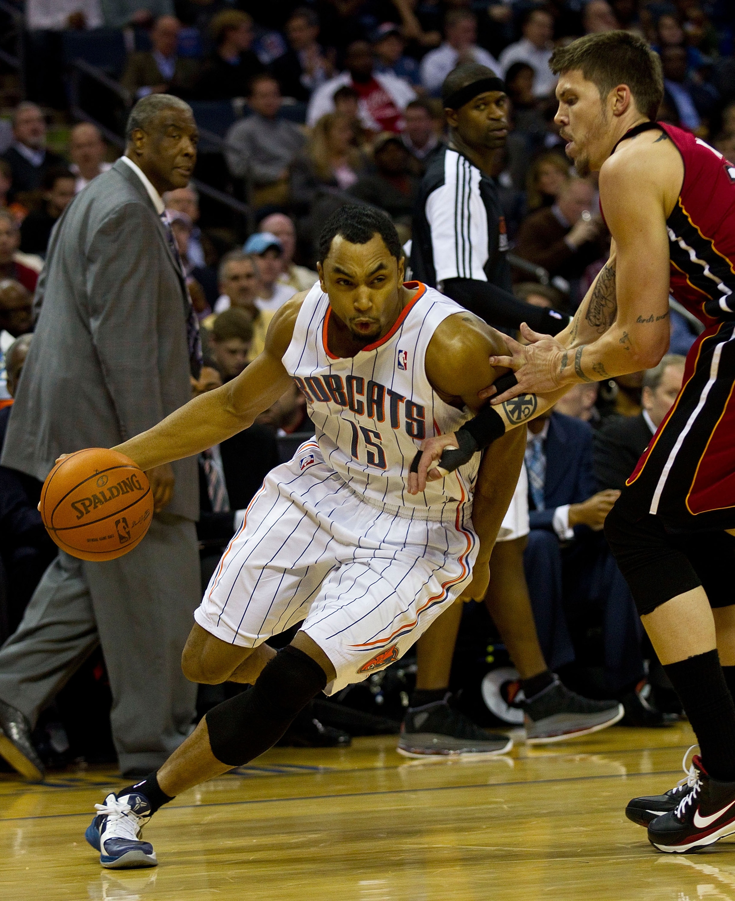 CHARLOTTE, NC - JANUARY 03: Gerald Henderson #15 of the Charlotte Bobcats drives the baseline past Mike Miller #13 of the Miami Heat at Time Warner Cable Arena on January 3, 2011 in Charlotte, North Carolina.  The Heat defeated the Bobcats 96-82.  (Photo