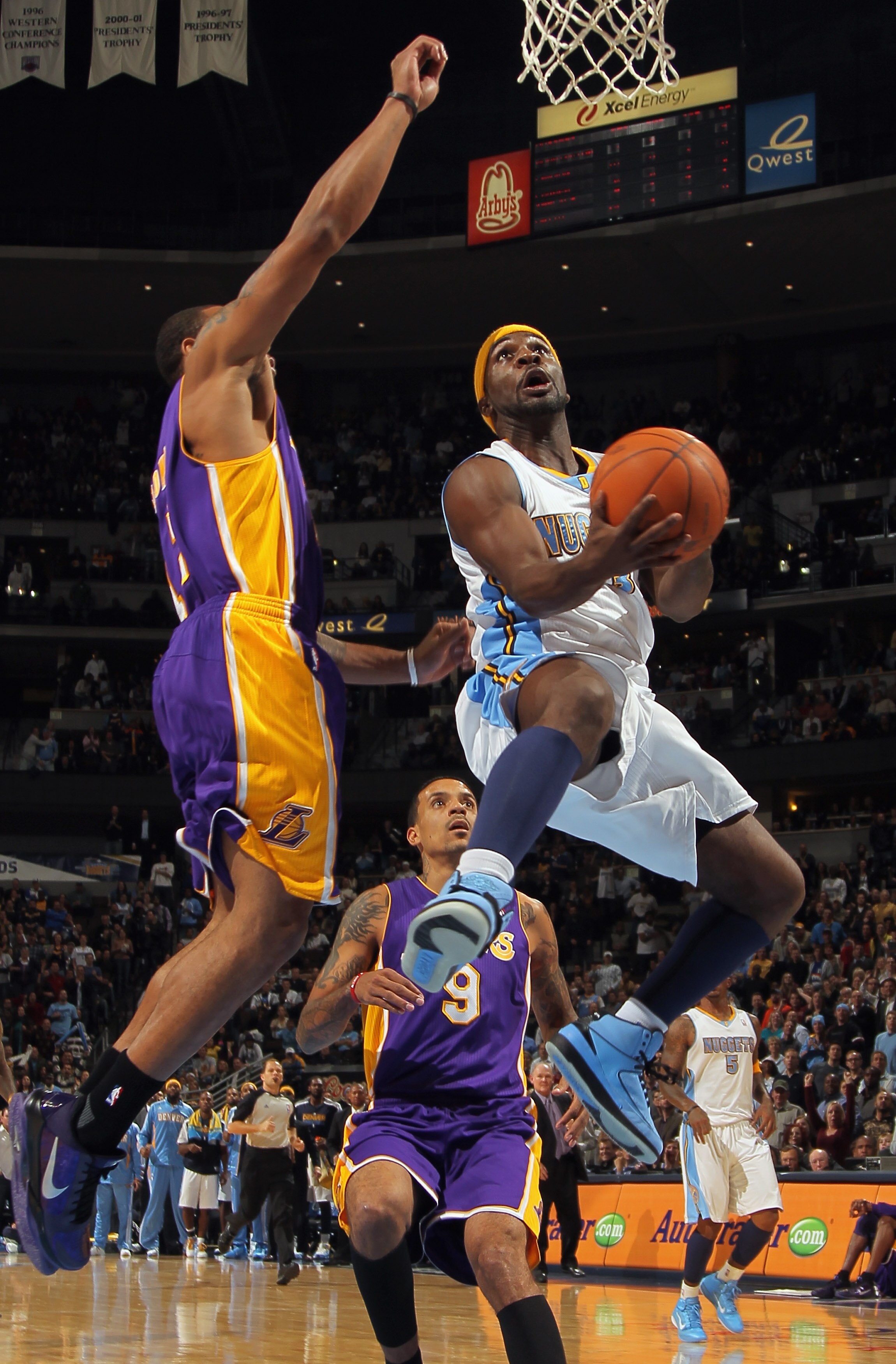 DENVER - NOVEMBER 11:  Ty Lawson #3 of the Denver Nuggets lays up a shot as Shannon Brown #12 of the Los Angeles Lakers defends at the Pepsi Center on November 11, 2010 in Denver, Colorado. The Nuggets defeated the Lakers 118-112.  NOTE TO USER: User expr