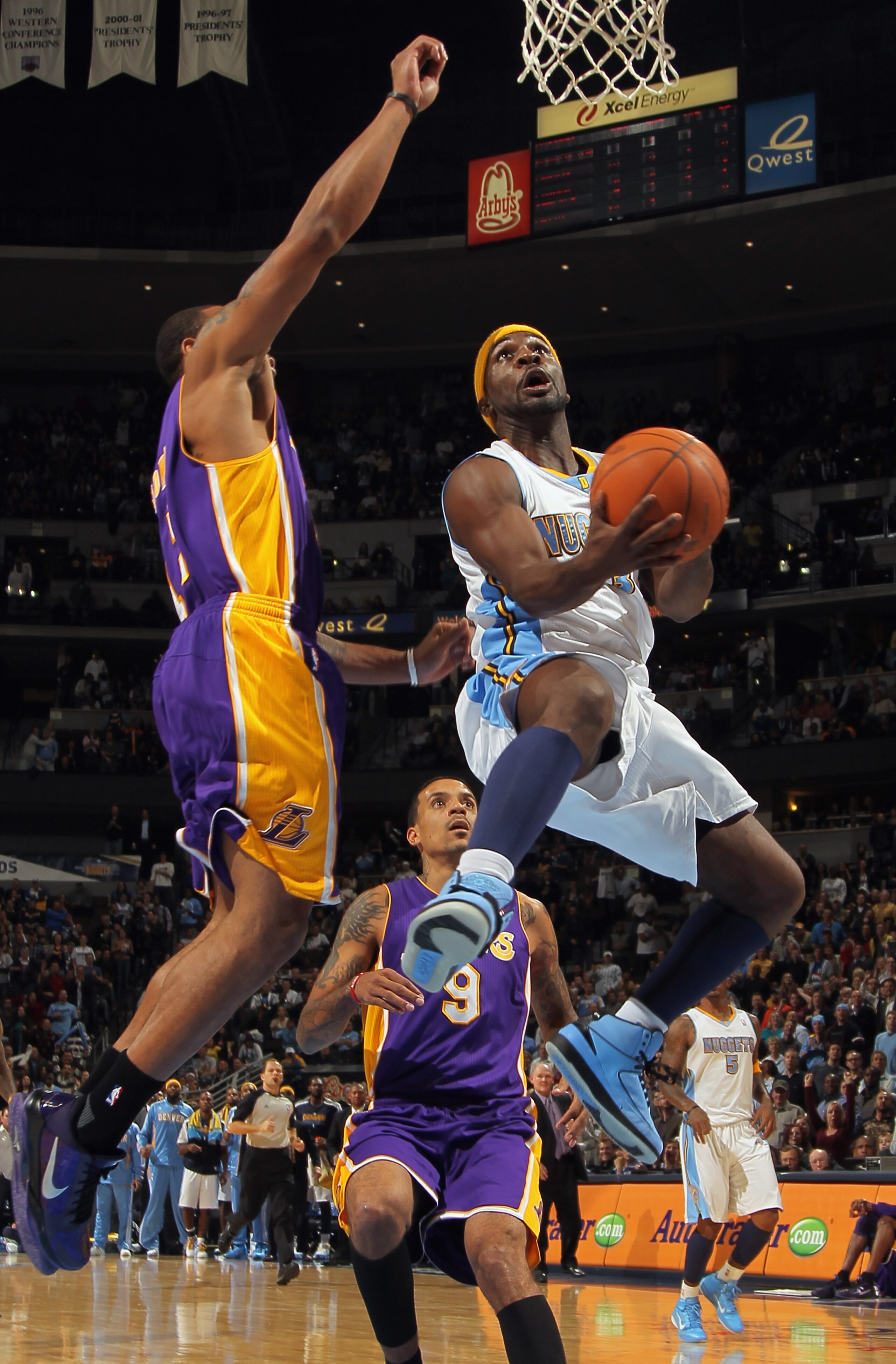 DENVER - NOVEMBER 11:  Ty Lawson #3 of the Denver Nuggets lays up a shot as Shannon Brown #12 of the Los Angeles Lakers defends at the Pepsi Center on November 11, 2010 in Denver, Colorado. The Nuggets defeated the Lakers 118-112.  NOTE TO USER: User expr