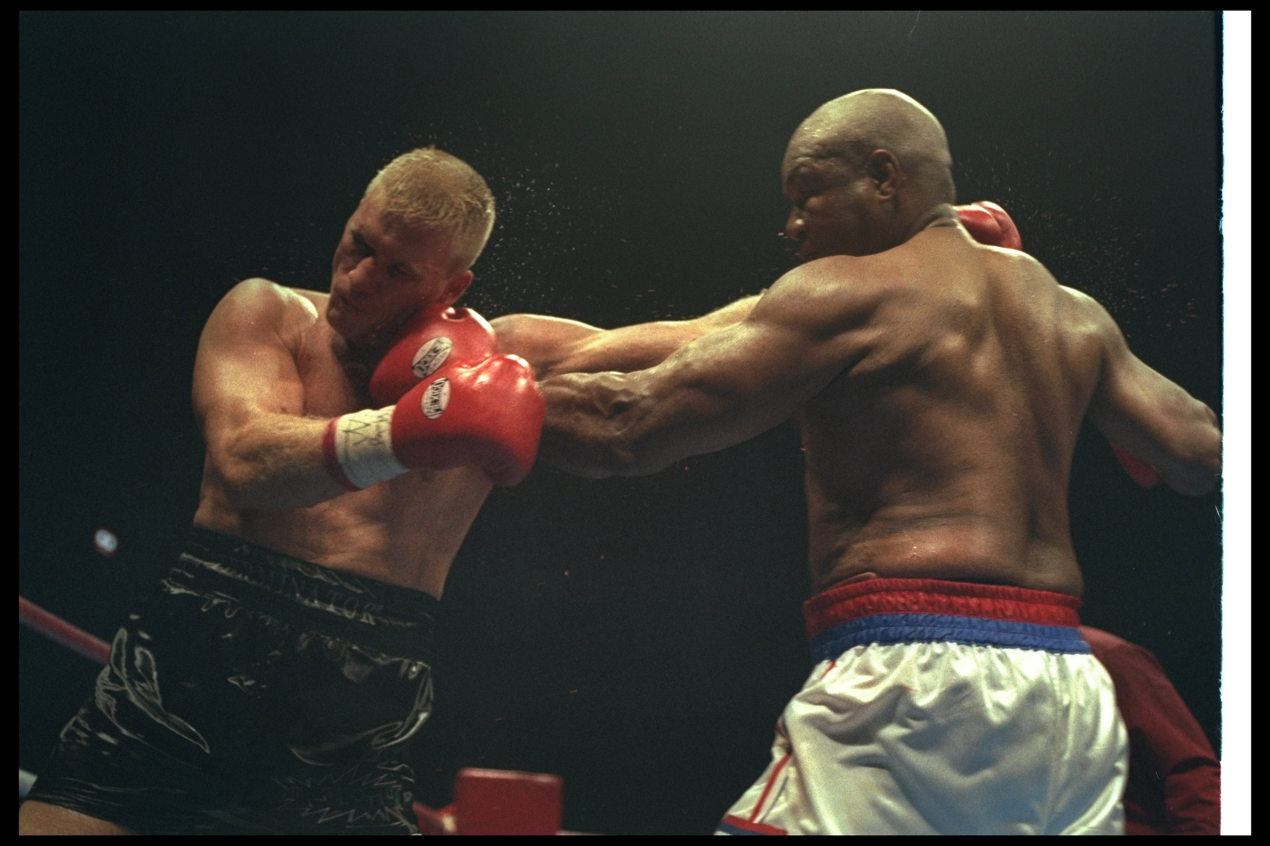 3 Nov 1996:  George Foreman (right) and Crawford Grimsley trade blows during a bout at Tokyo Bay NK Hall in Tokyo, Japan.  Foreman won the fight by a decision in the twelfth round. Mandatory Credit: Al Bello  /Allsport