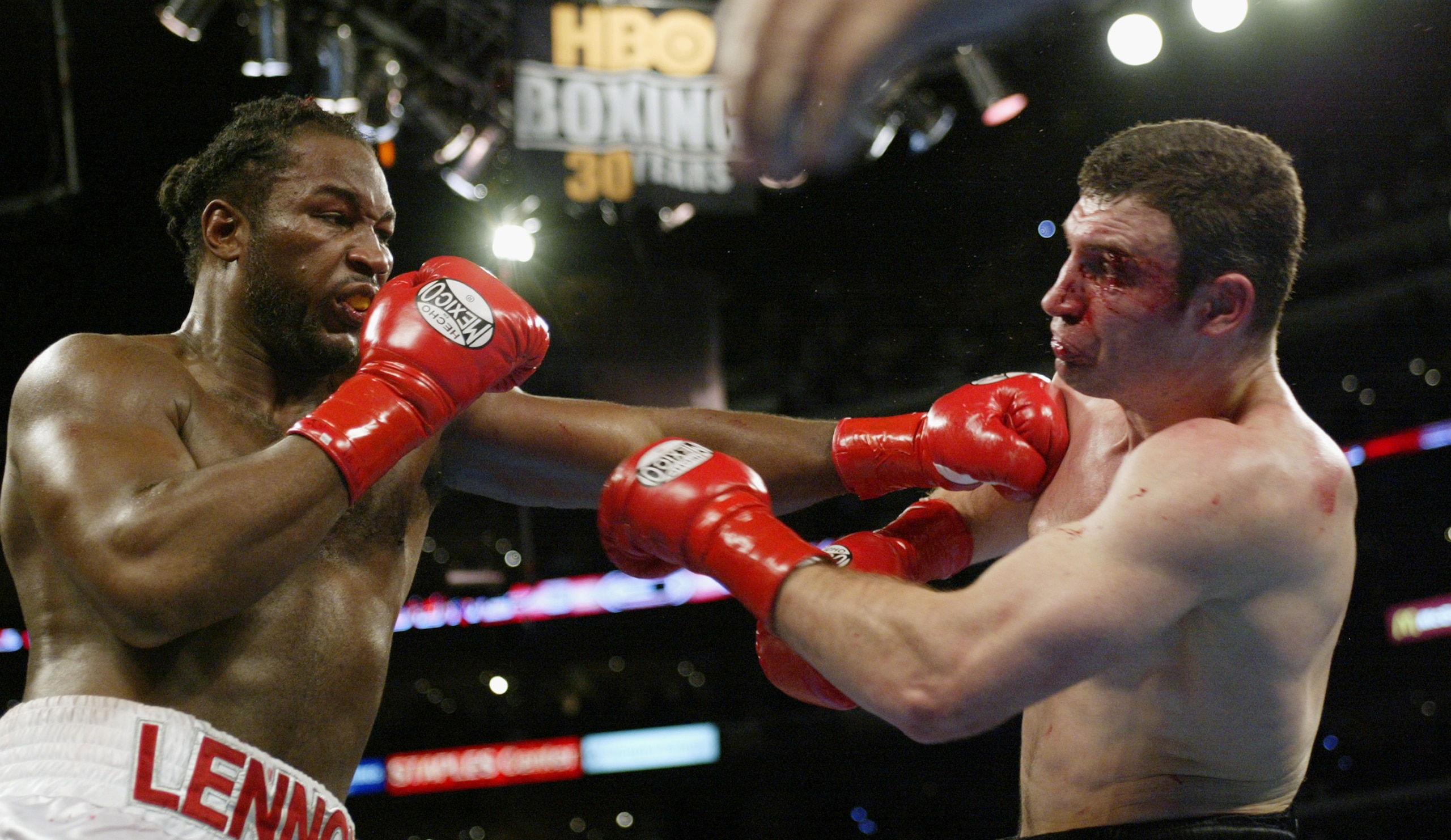 LOS ANGELES - JUNE 21:  Lennox Lewis (left) hits Vitali Klitschko (right) during their WBC and IBO World Heavyweight Championship bout at the Staples Center on June 21, 2003 in Los Angeles, California.  Lennox Lewis (41-2-1) was handed a sixth-round techn