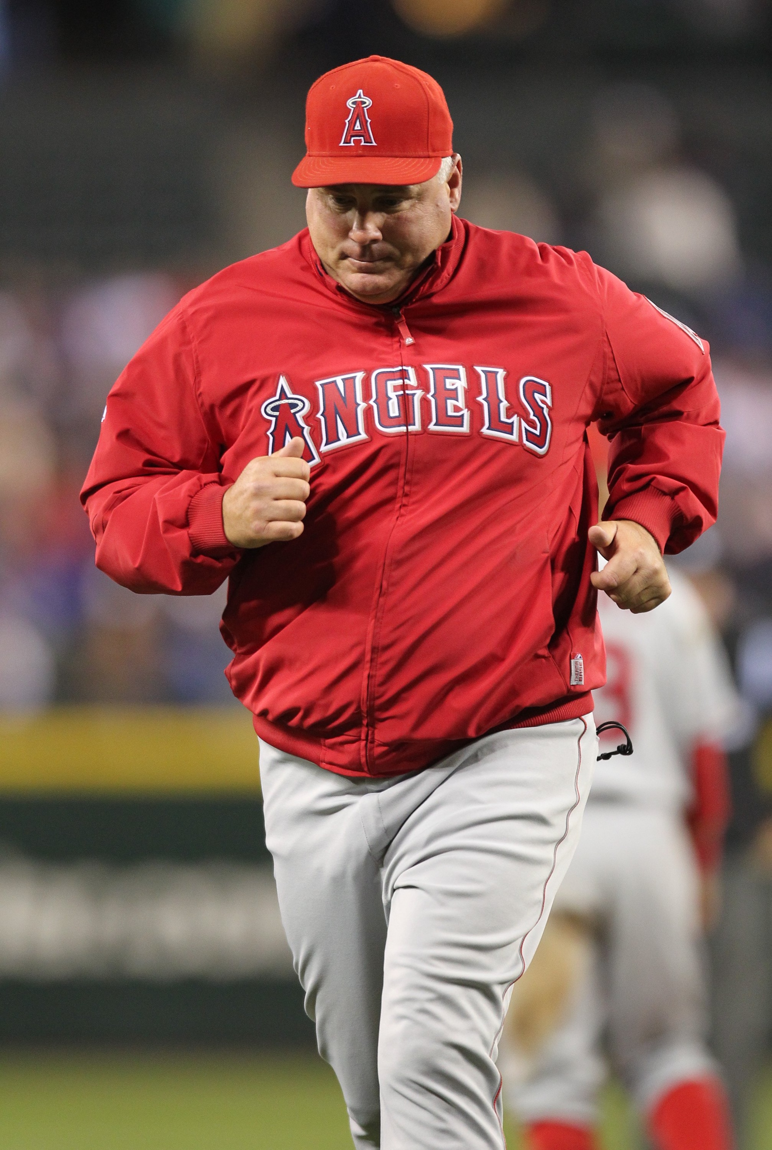 SEATTLE - JUNE 04:  Manager Mike Scioscia #14 of the Los Angeles Angels of Anaheim returns to the dugout after a visit to the mound during the game against the Seattle Mariners at Safeco Field on June 4, 2010 in Seattle, Washington. (Photo by Otto Greule