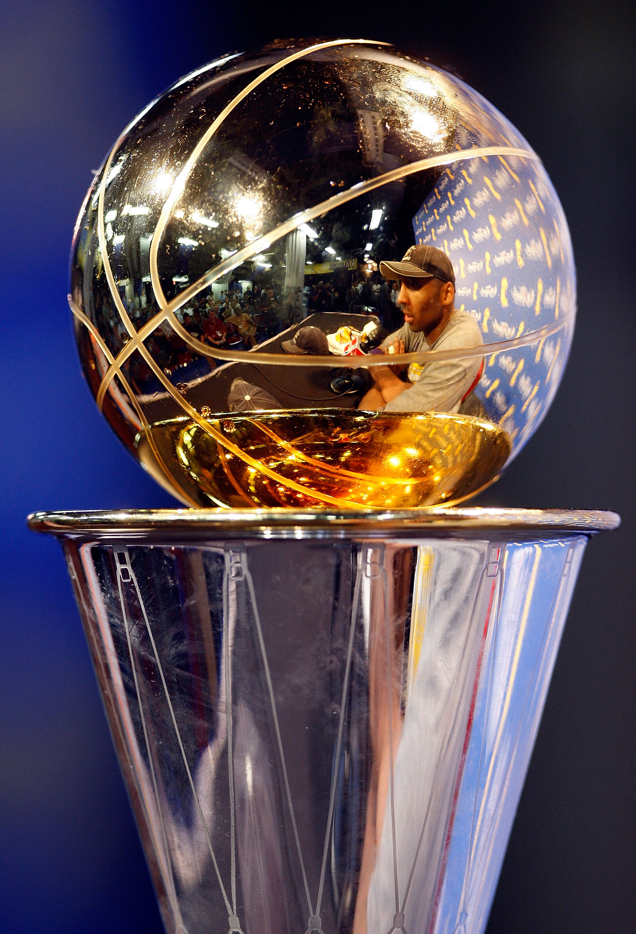 ORLANDO, FL - JUNE 14:  A reflection off of the Bill Russell MVP Trophy of Kobe Bryant #24 of the Los Angeles Lakers during the post game news conference after the Lakers defeated the Orlando Magic 99-86 to win the NBA Championship in Game Five of the 200