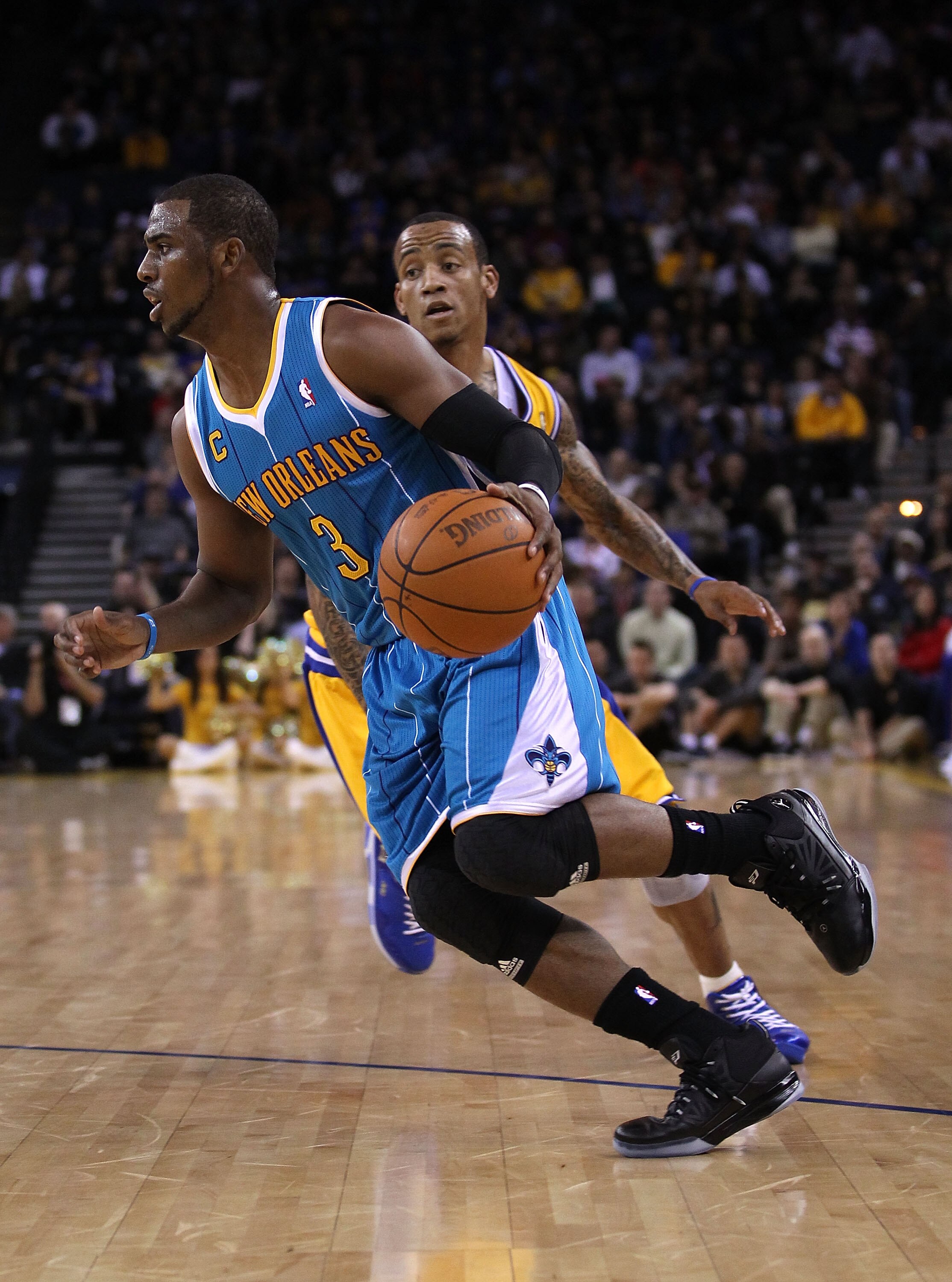 OAKLAND, CA - FEBRUARY 15:  Chris Paul #3 of the New Orleans Hornets drives on Monta Ellis #8 of the Golden State Warriors at Oracle Arena on February 15, 2011 in Oakland, California. NOTE TO USER: User expressly acknowledges and agrees that, by downloadi