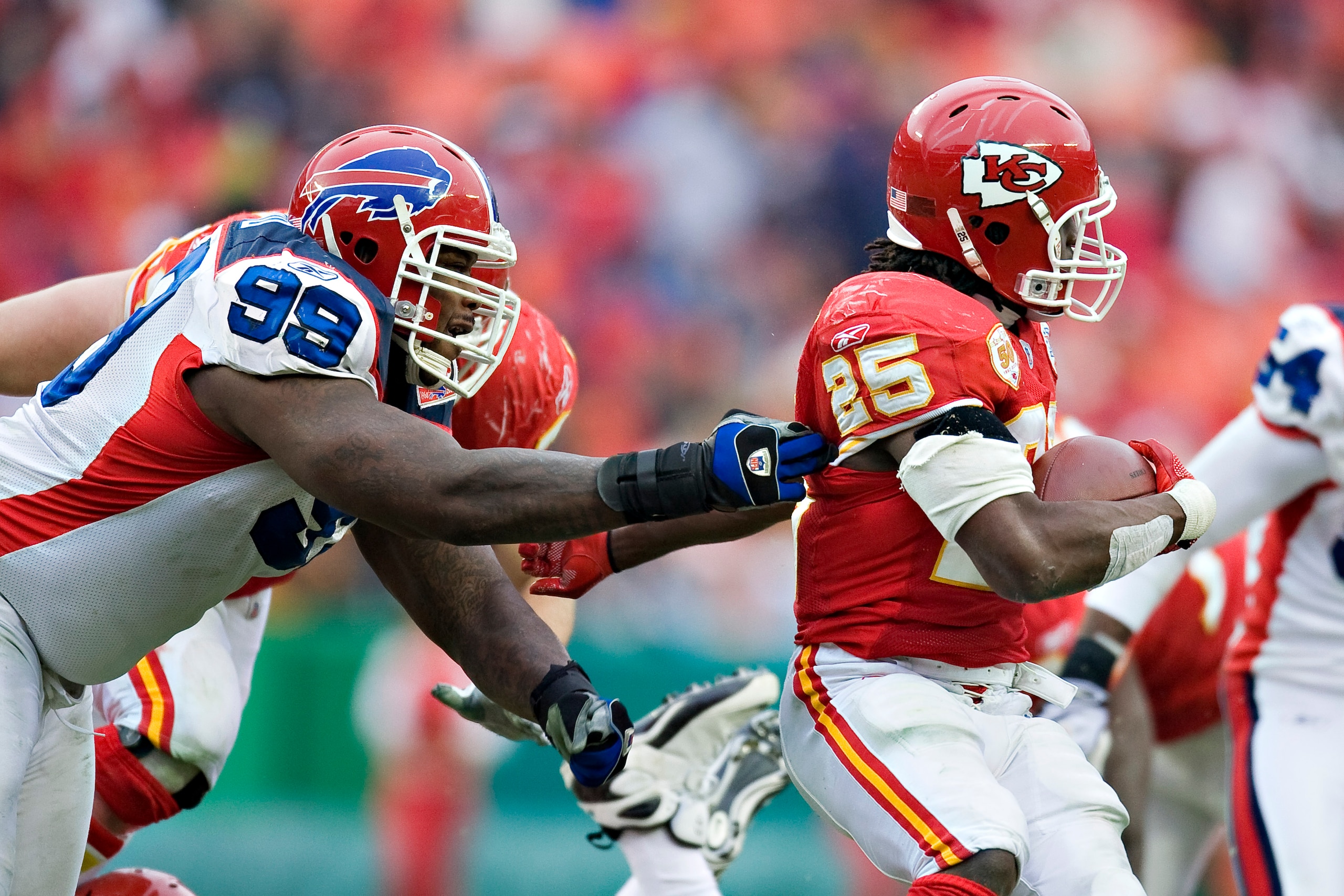 KANSAS CITY, MO - DECEMBER 13: Defensive tackle Marcus Stroud #99 of the Buffalo Bills grabs the jersey of running back Jamaal Charles #25 of the Kansas City Chiefs at Arrowhead Stadium on December 13, 2009 Kansas City, Missouri.  The Bills defeated the C