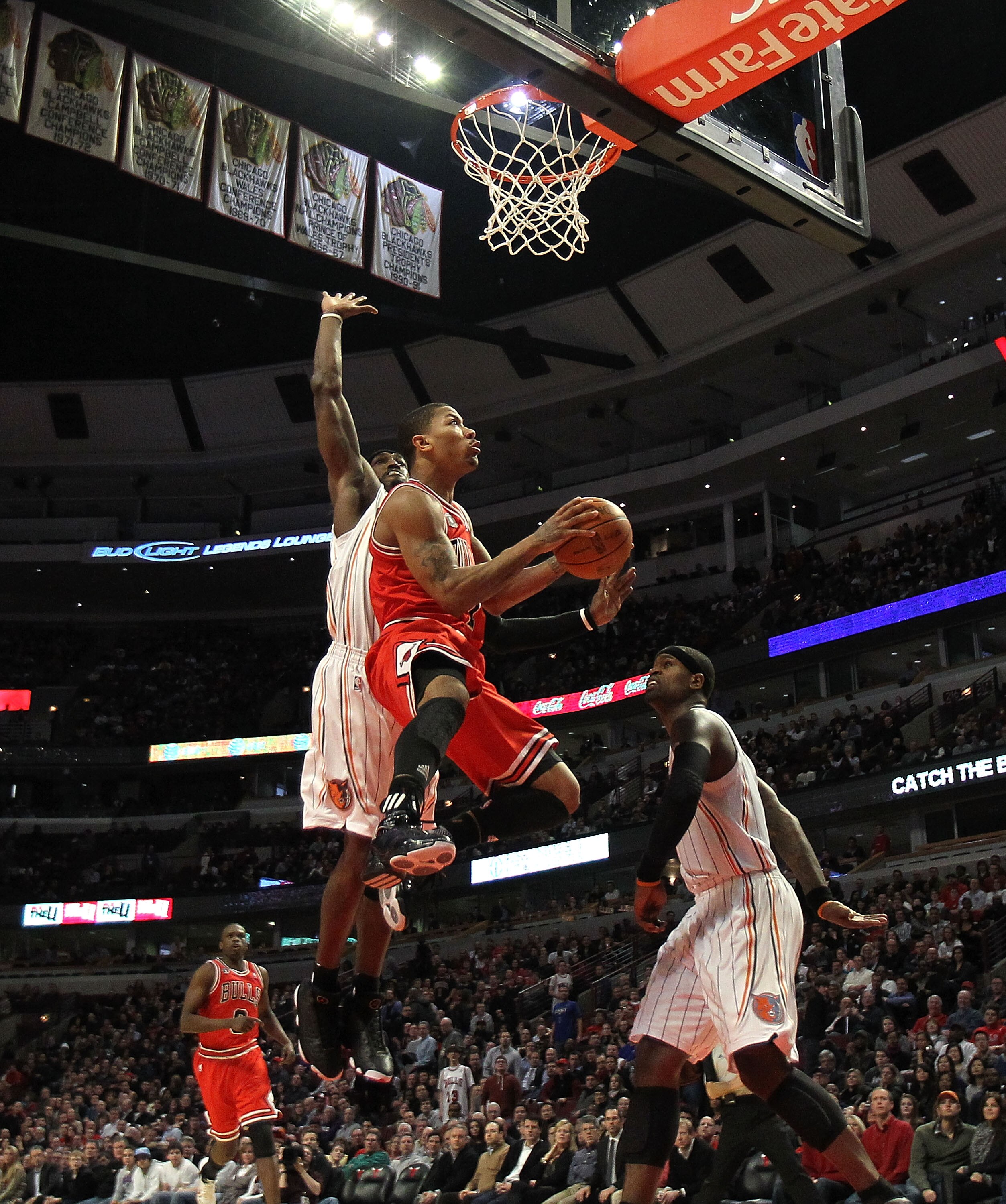 CHICAGO, IL - FEBRUARY 15: Derrick Rose #1 of the Chicago Bulls goes up for a shot against Gerald Wallace #3 and Stephen Jackson #1 of the Charlotte Bobcats at the United Center on February 15, 2011 in Chicago, Illinois. The Bulls defeated the Bobcats 106