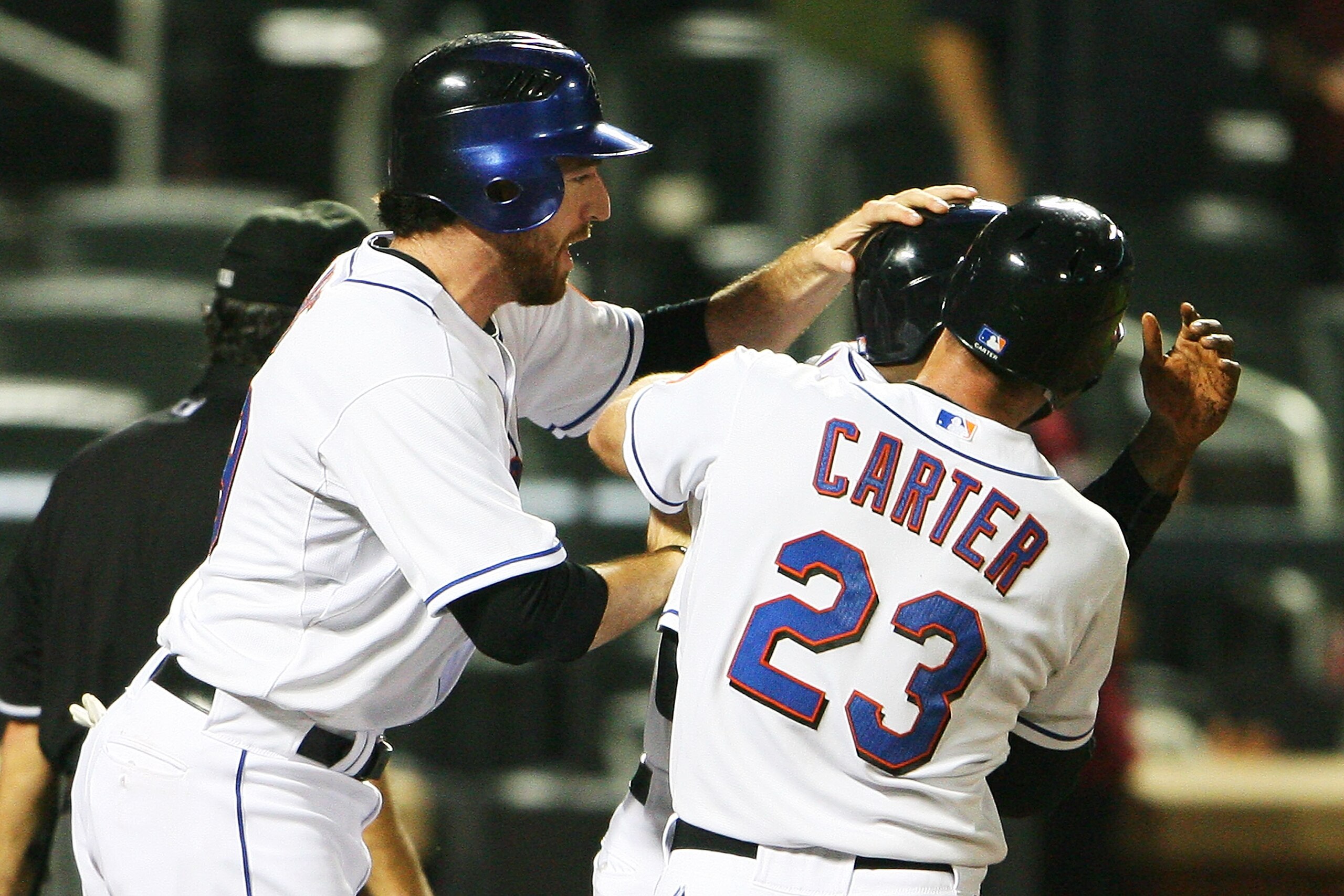 NEW YORK - SEPTEMBER 28:  Ike Davis #29 (L) and Chris Carter #23 celebrate with Luis Castillo #1 of the New York Mets after Davis and Carter scored the winning runs off of a walk off two run double hit by Ruben Tejada against the Milwaukee Brewers on Sept