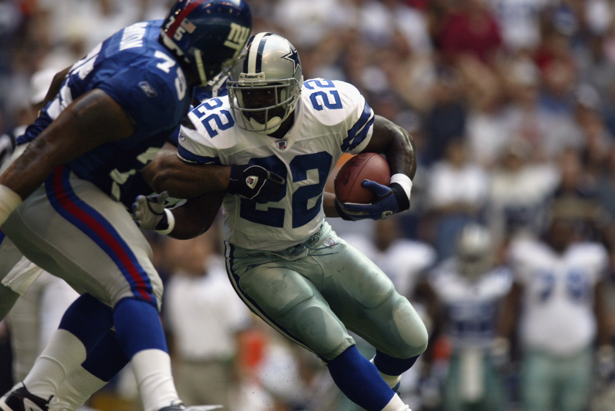 IRVING, TX - OCTOBER 6:  Running back Emmitt Smith #22 of the Dallas Cowboys carries the ball against defensive end Bob Jones #79 of the New York Giants during the NFL game on October 6, 2002 at Texas Stadium in Irving, TX.  The Giants defeated the Cowboy