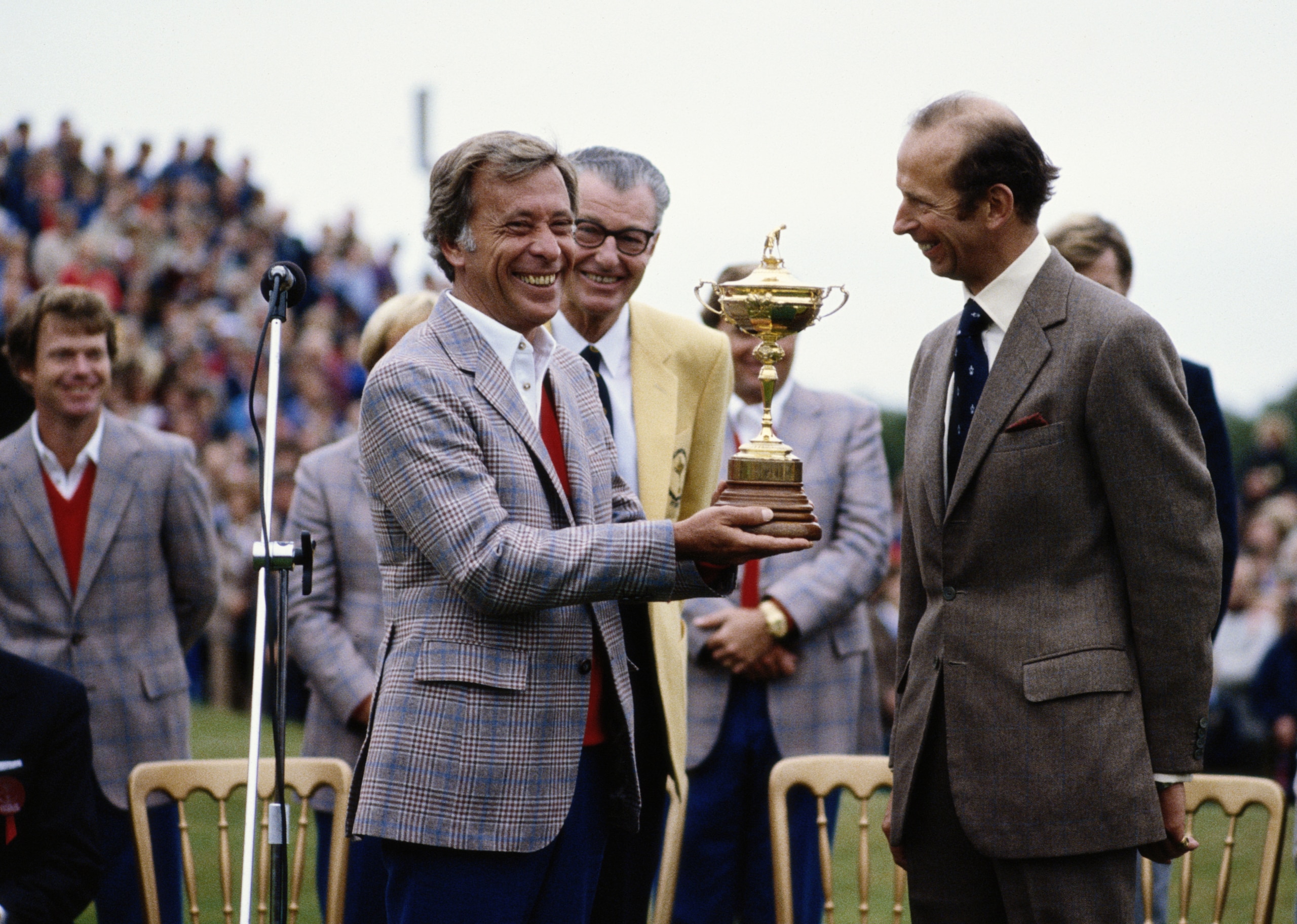 Dave Marr, captain of the United States team recieves the Ryder Cup trophy from HRH Duke of Kent as Tom Watson (l) looks on in the background during the  24th Ryder Cup Matches on 27 September 1981 at Walton Heath Golf Club in Walton-on-the-Hill, Surrey,
